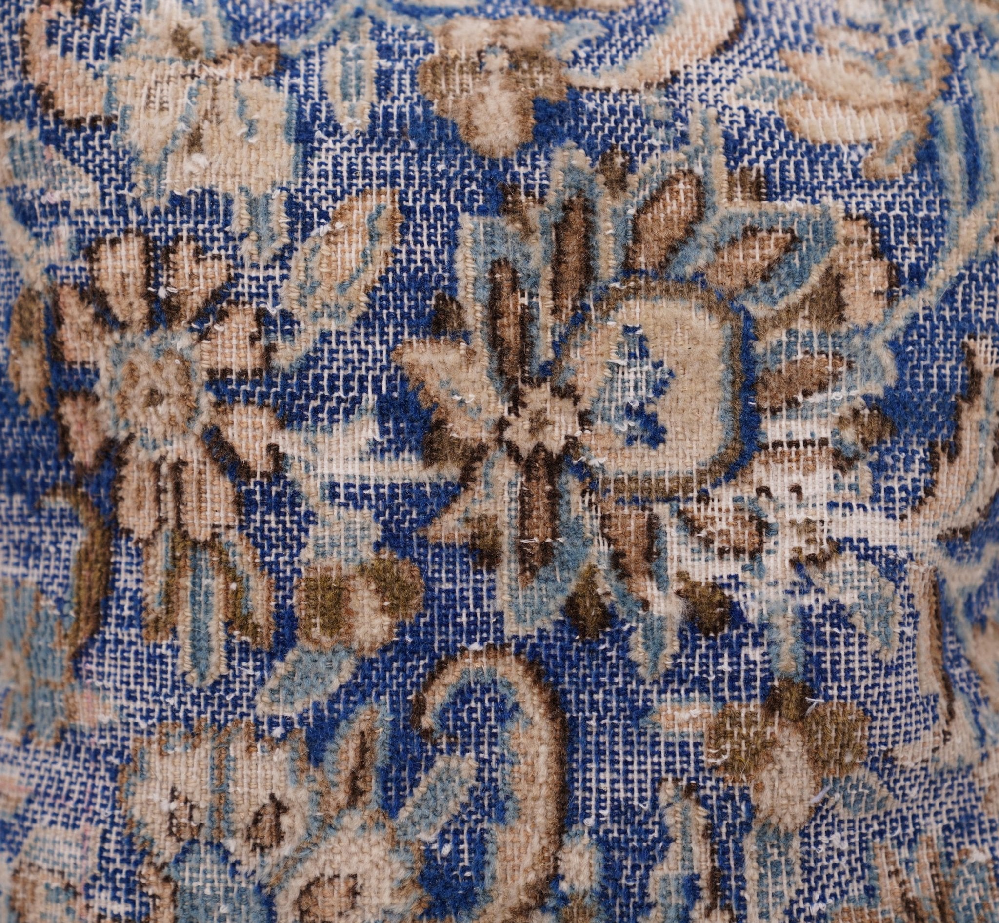 Close-up of a floral patterned fabric with blue and beige colors.