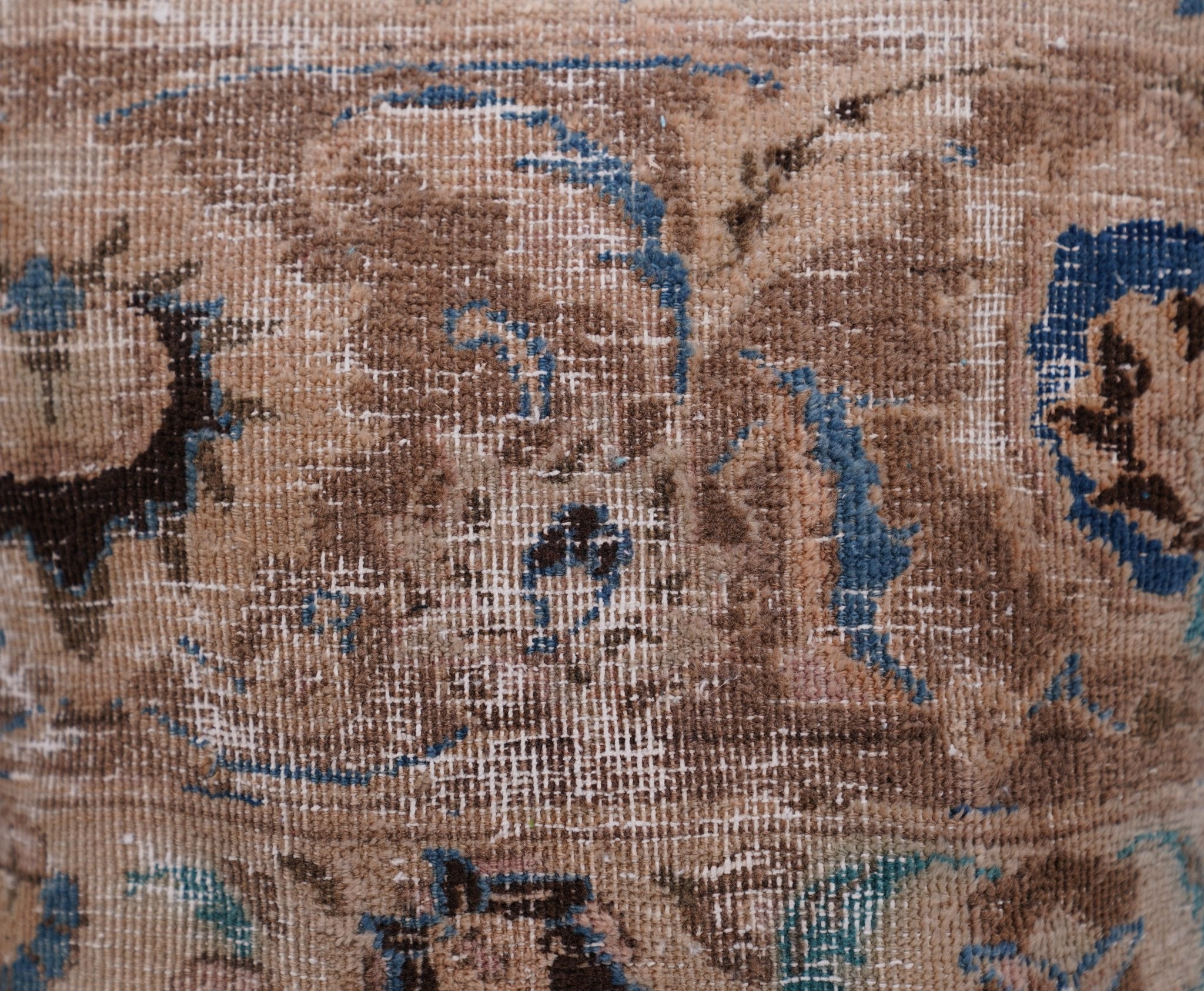 Close-up of an intricate rug with blue and brown patterns
