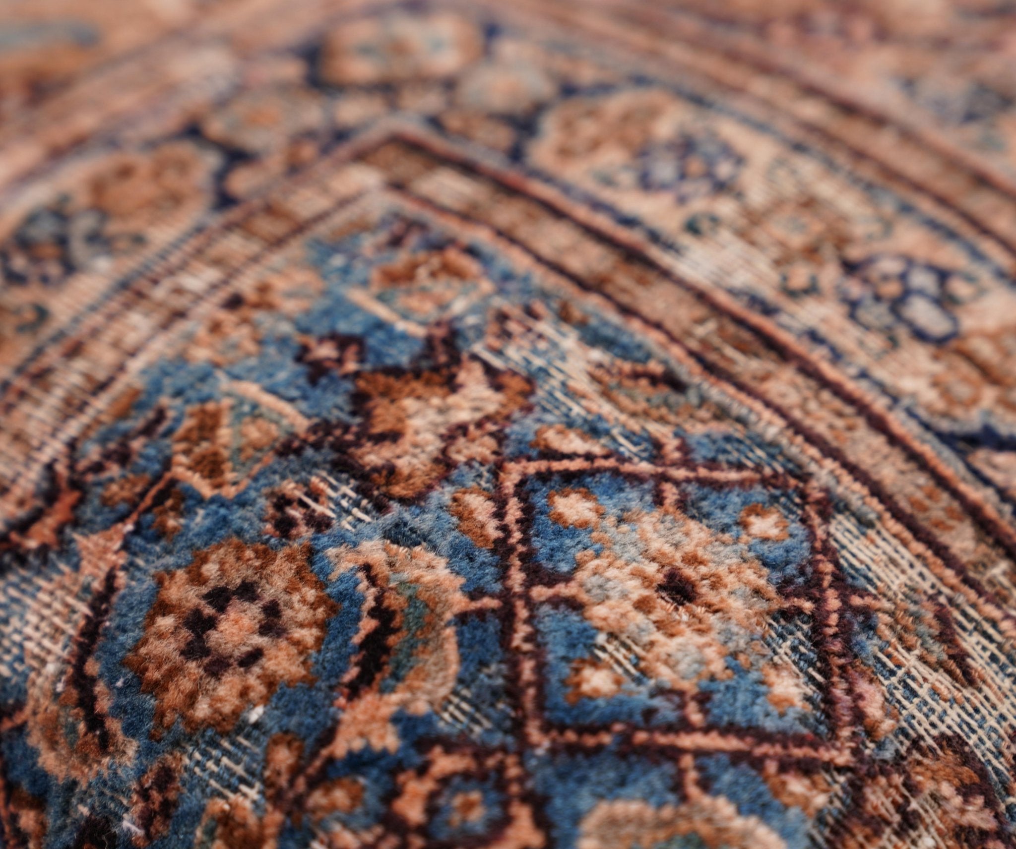 Close-up of a patterned rug with intricate designs.