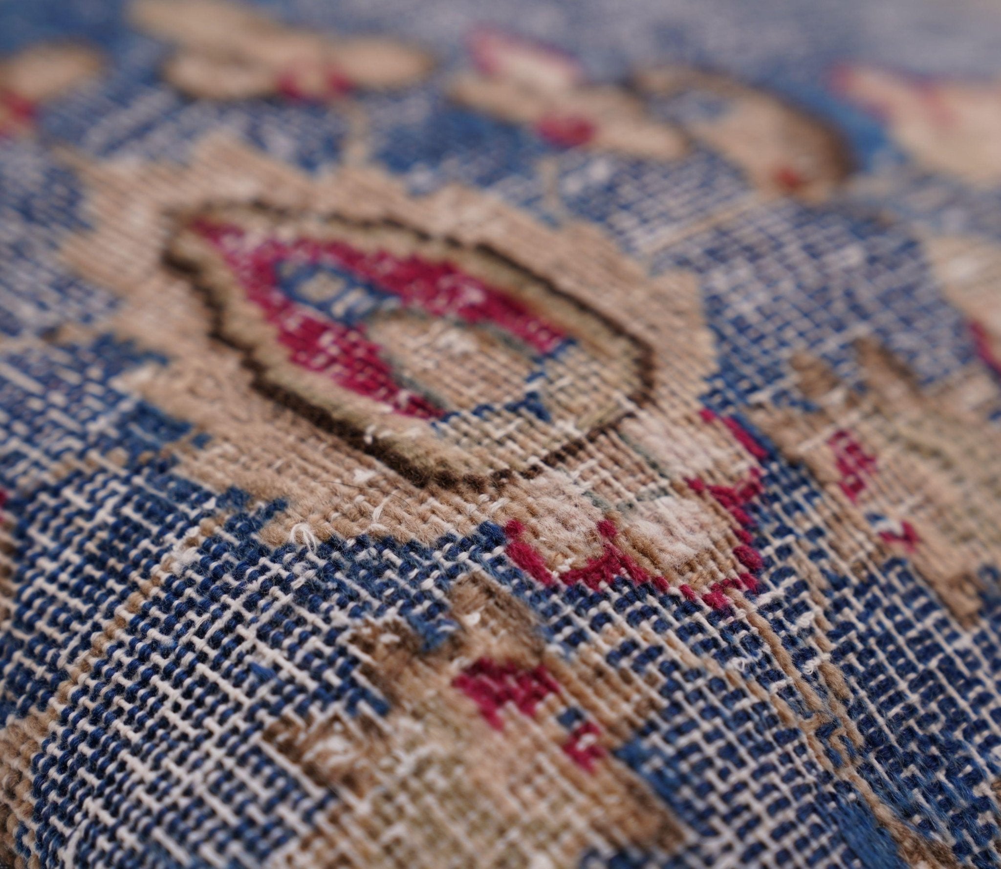 Close-up of a textured fabric with intricate patterns and colors.