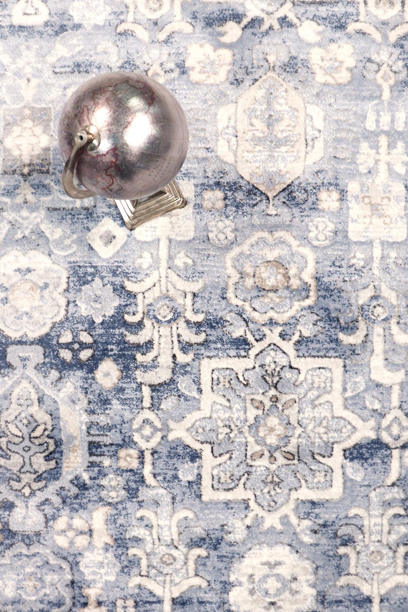 Decorative rug with intricate patterns and a metallic object on top