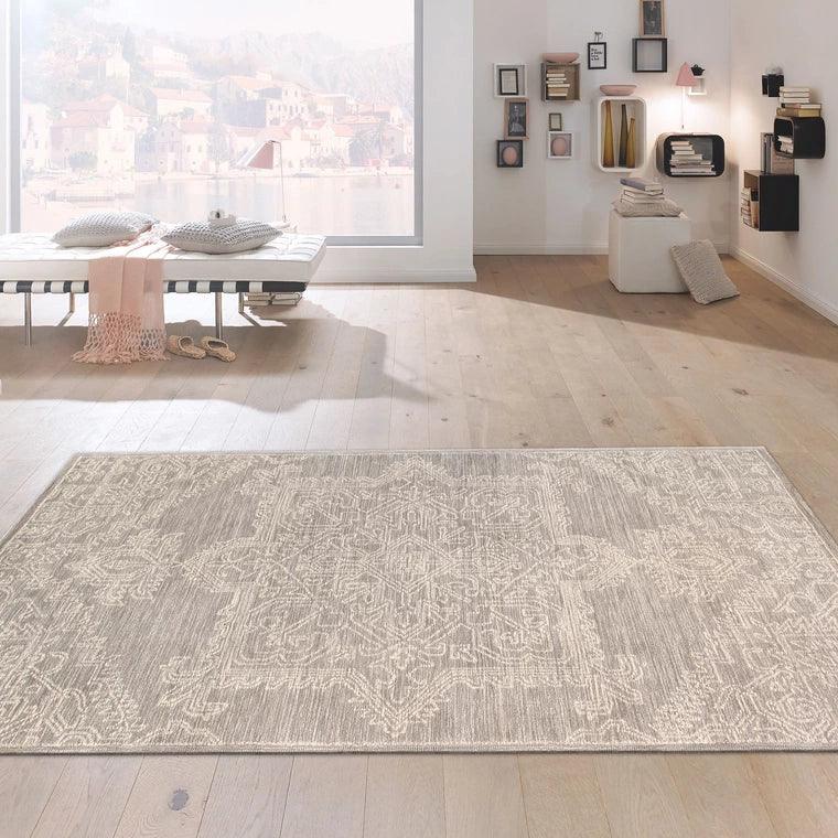 Patterned rug on a wooden floor with a modern room setting.