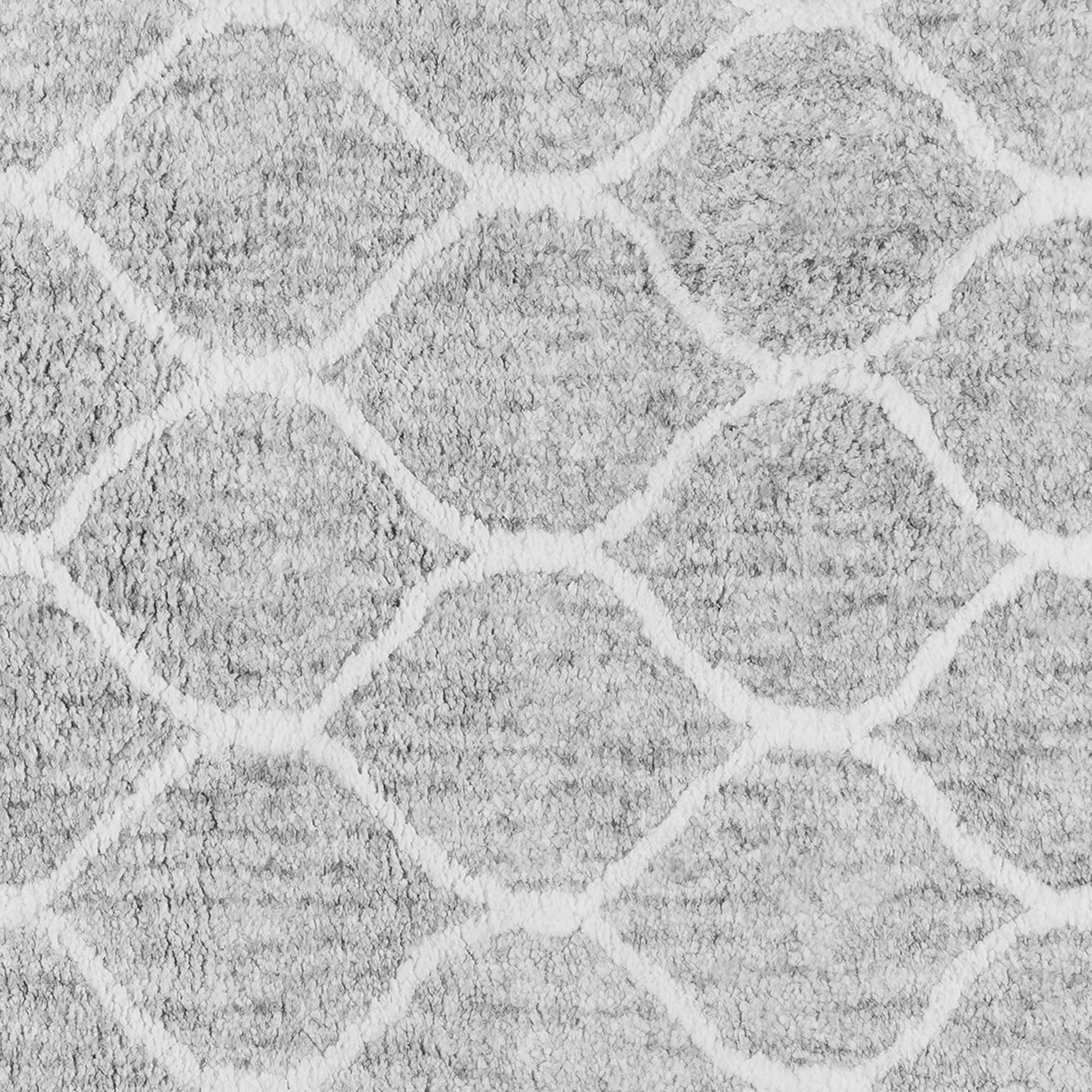 Close-up of a textured gray carpet with a diamond pattern