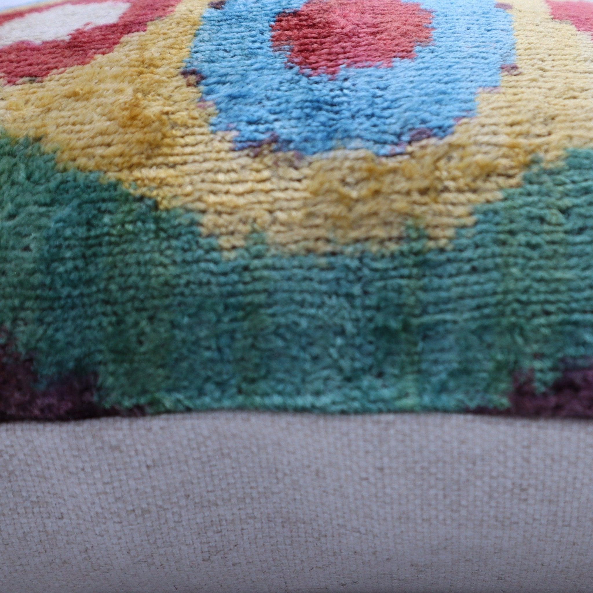 Multicolored textured cushion on a gray surface