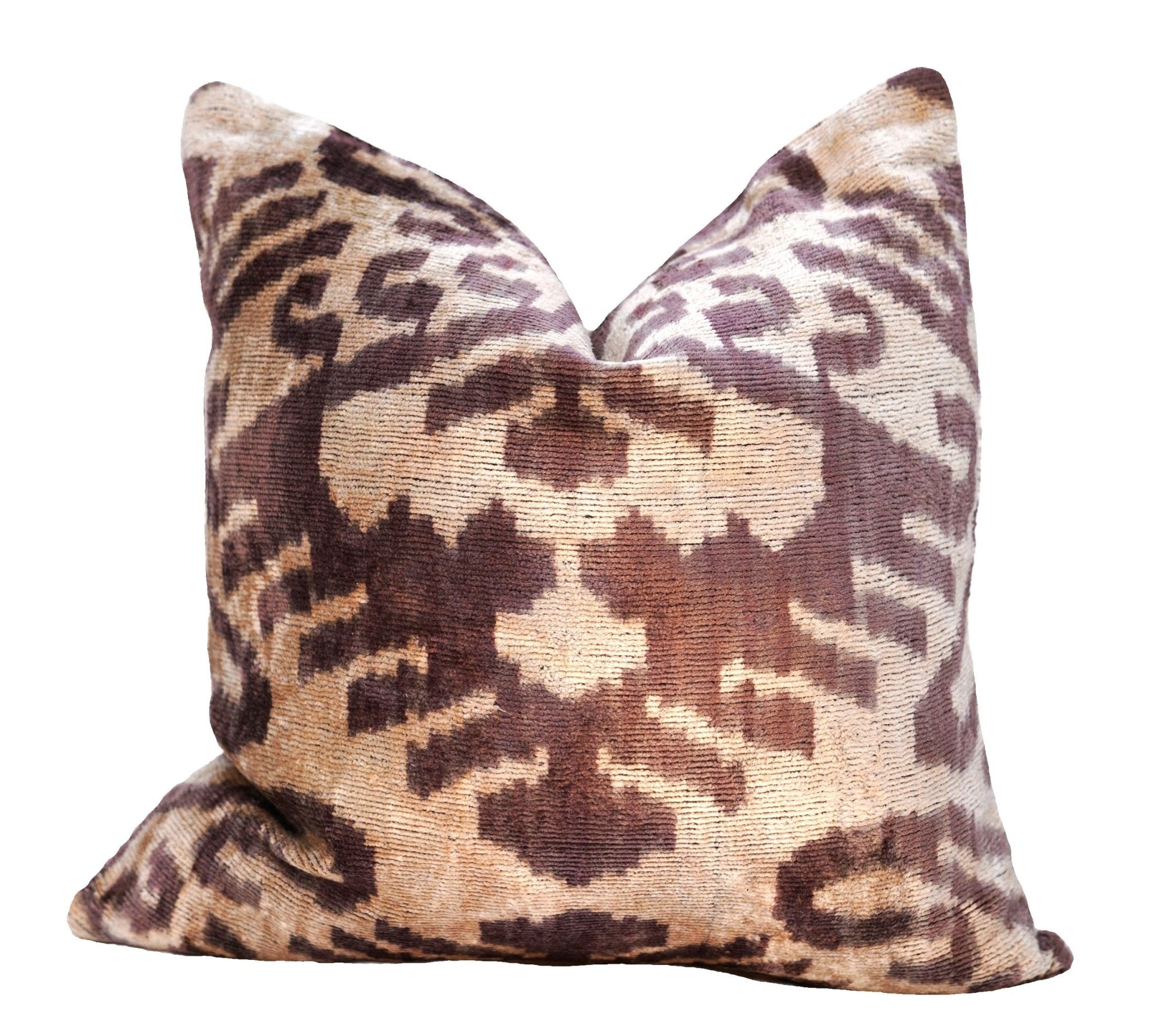 Patterned pillow with brown and beige design on a white background