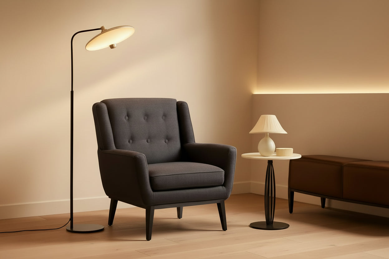 Gray armchair in a room with a floor lamp and side table.
