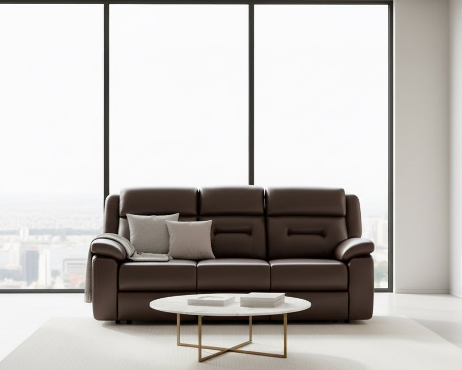 Brown leather sofa in a room with beige walls and a small table.