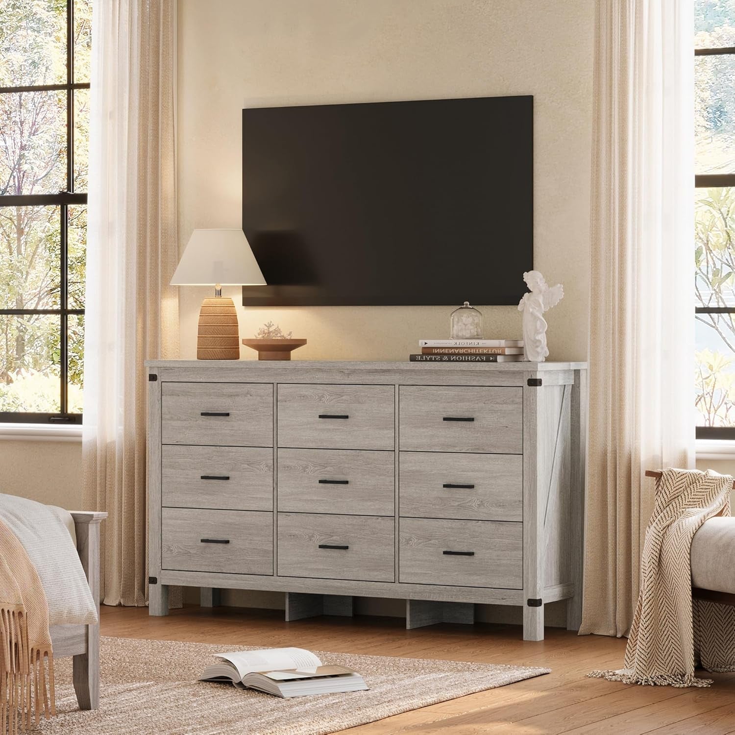Gray dresser with a television above it in a room with curtains and a rug.