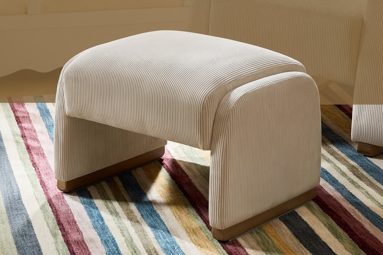 Beige ottoman with rounded silhouette on a striped rug, with text about unique design.