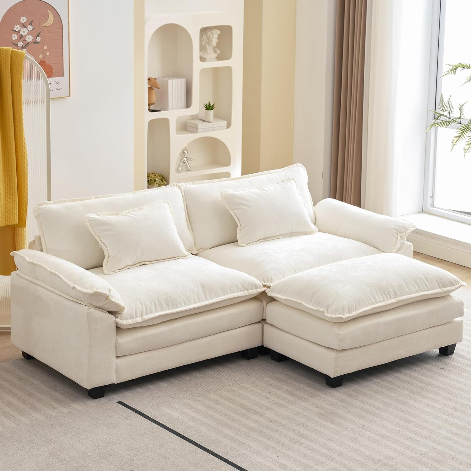 White sectional sofa in a living room setting with decor elements.