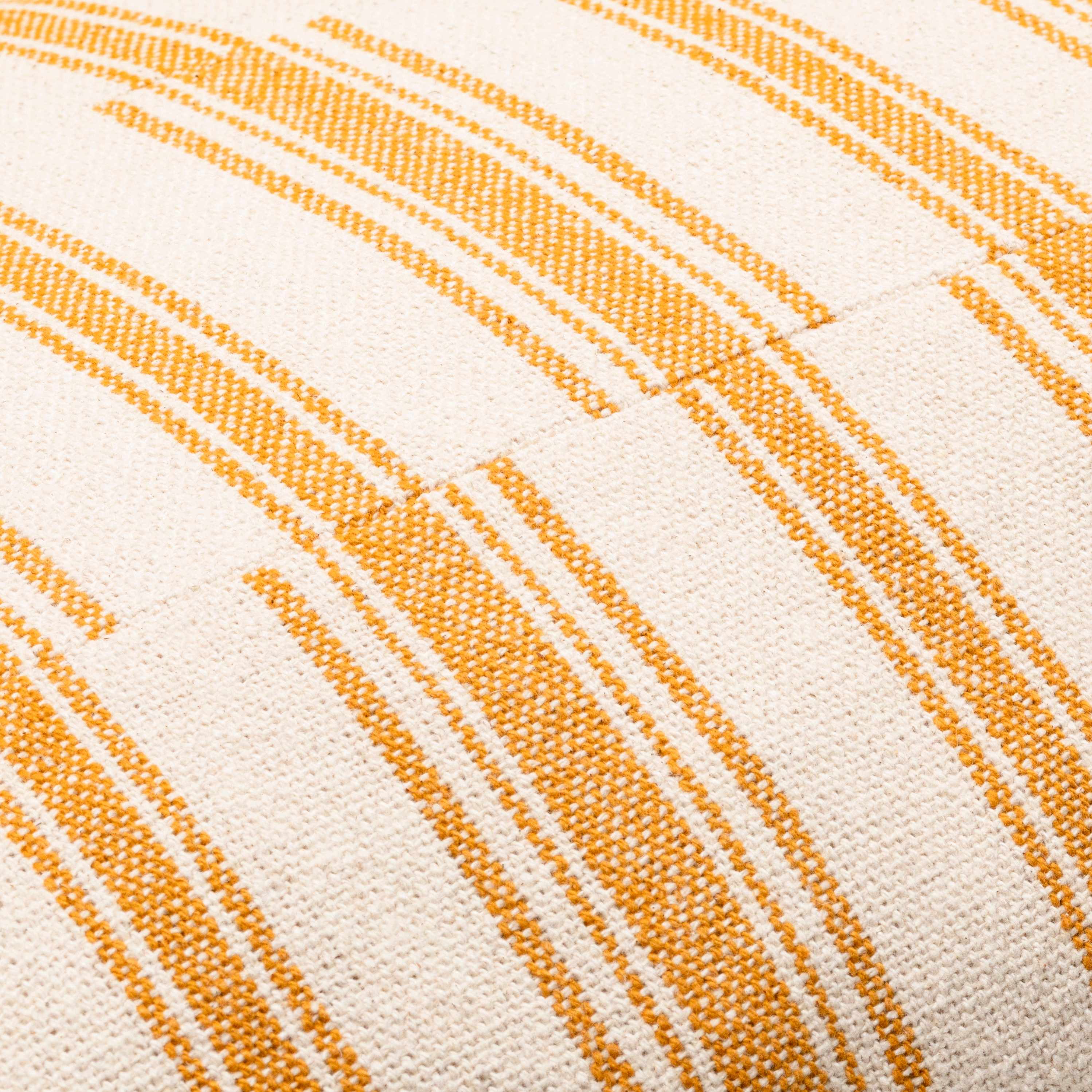 Close-up of fabric with orange diagonal stripes on a beige background