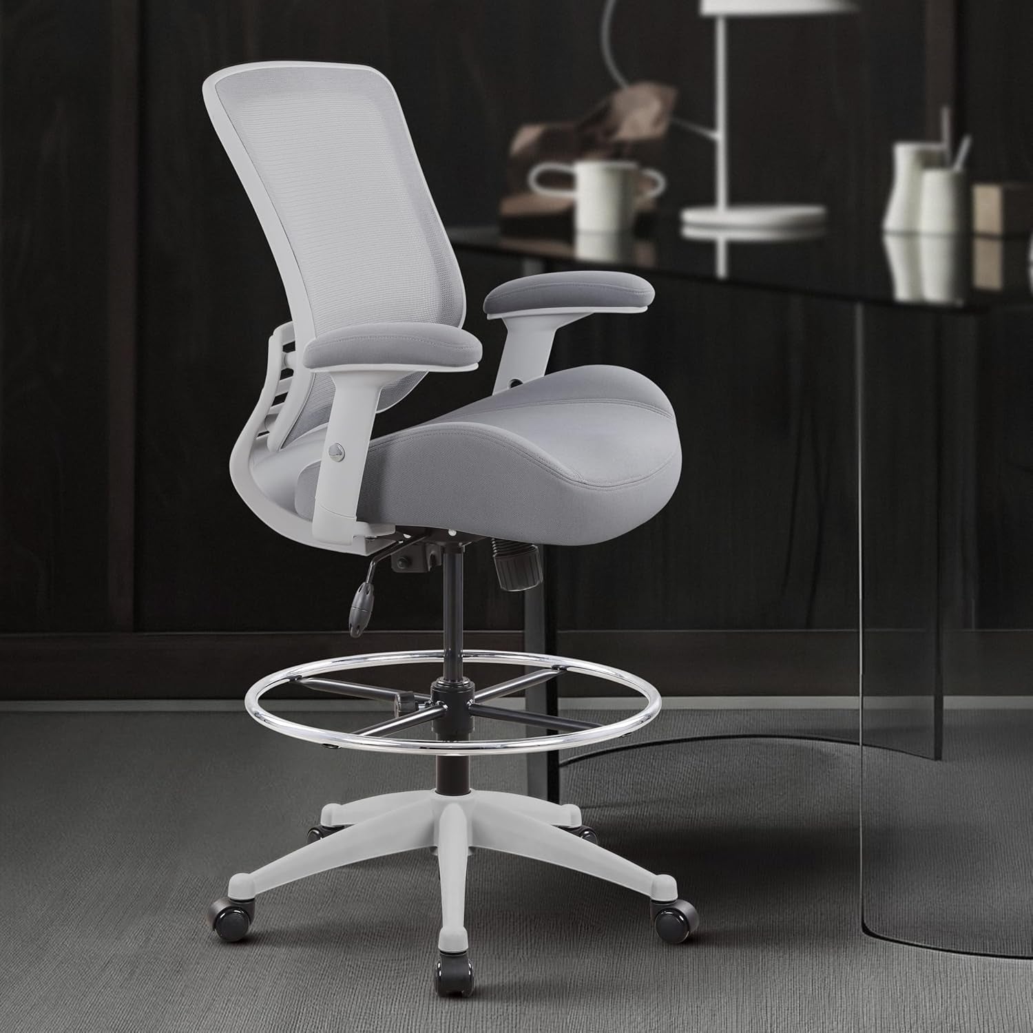 Gray office chair with adjustable arms in a modern office setting