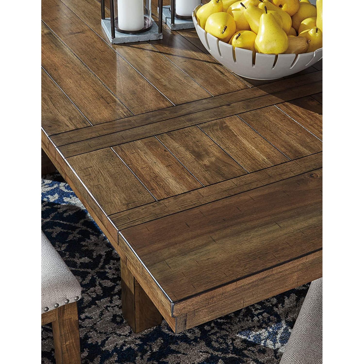 Wooden dining table with a bowl of pears on a patterned rug