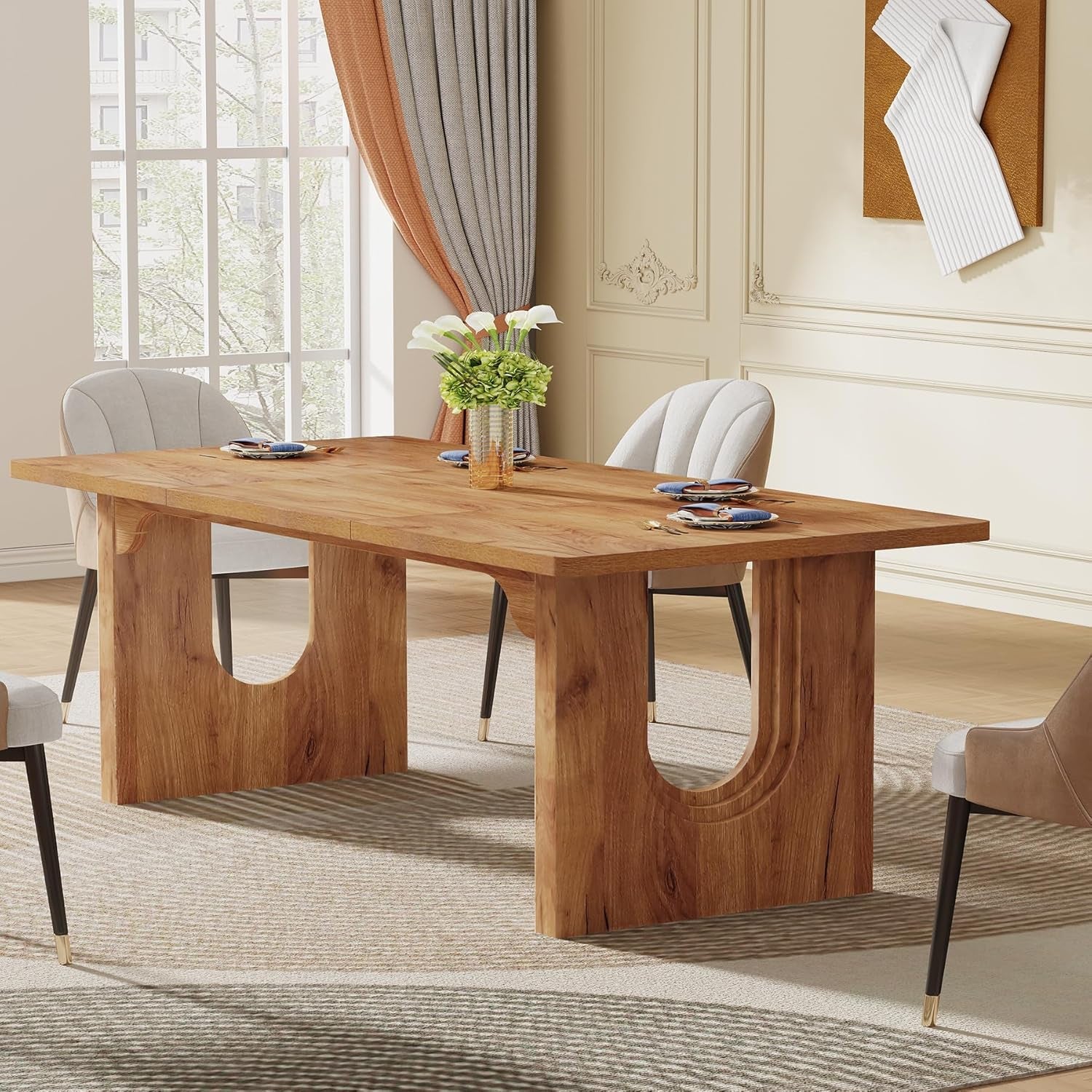 Wooden dining table with chairs in a room with large windows and curtains.