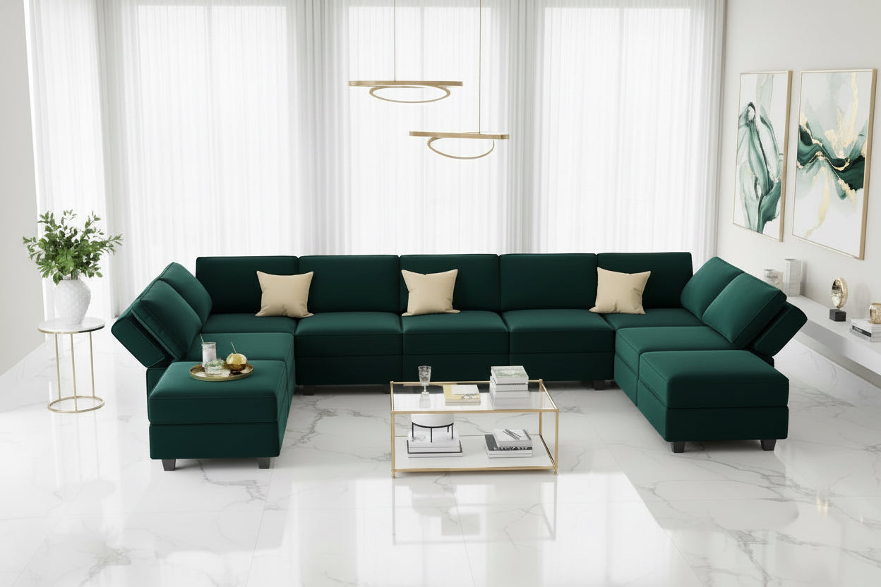 Green sectional sofa in a modern living room with a kitchen in the background.