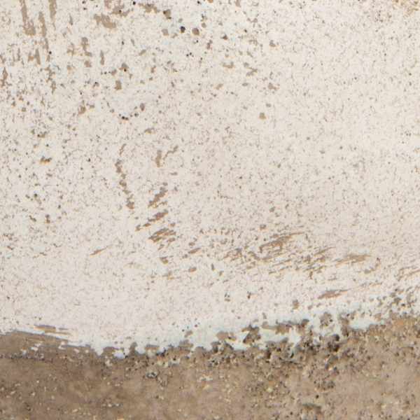 Close-up of a textured concrete surface with beige and brown tones.