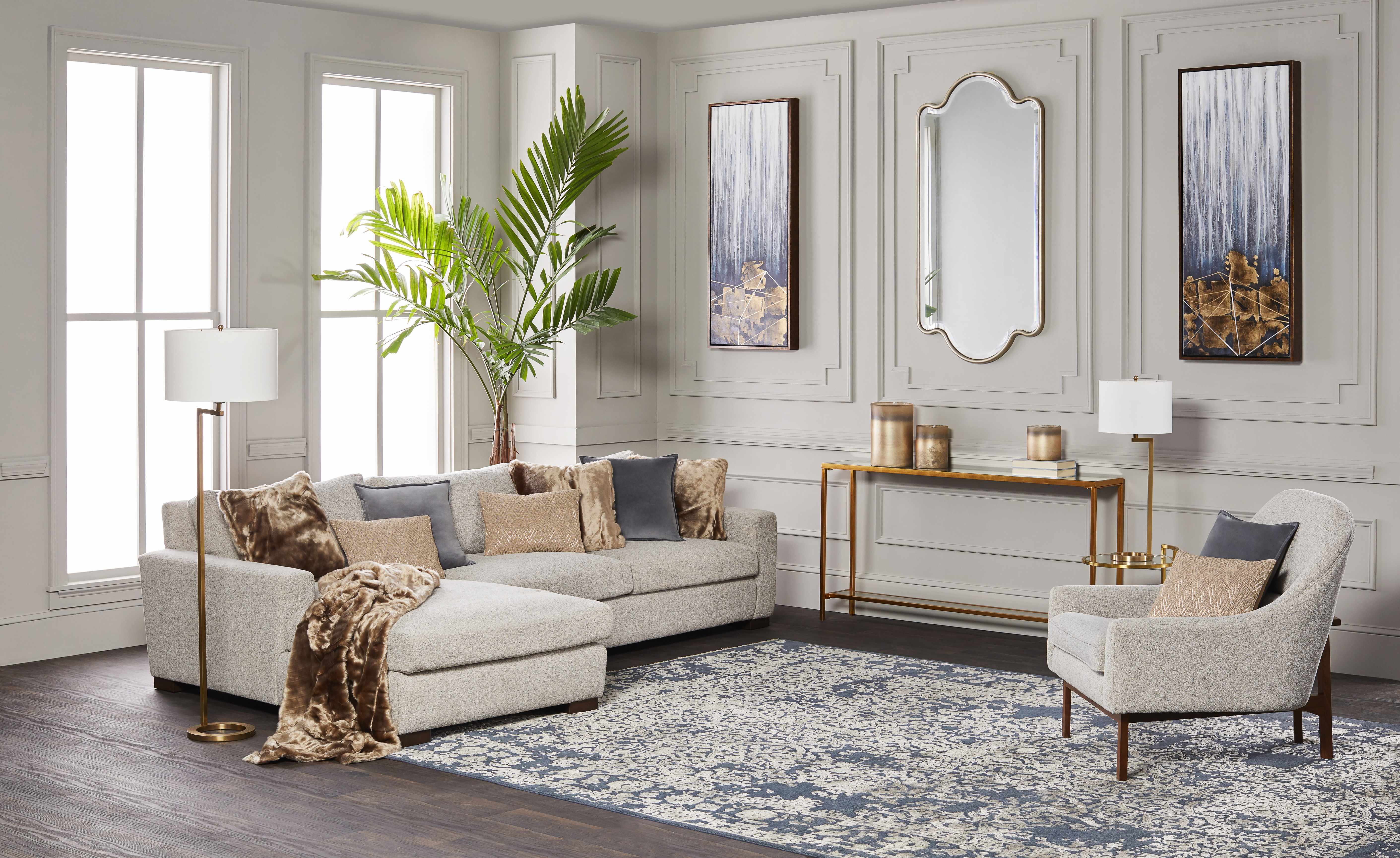 Modern living room with a sectional sofa, armchair, and decorative elements.