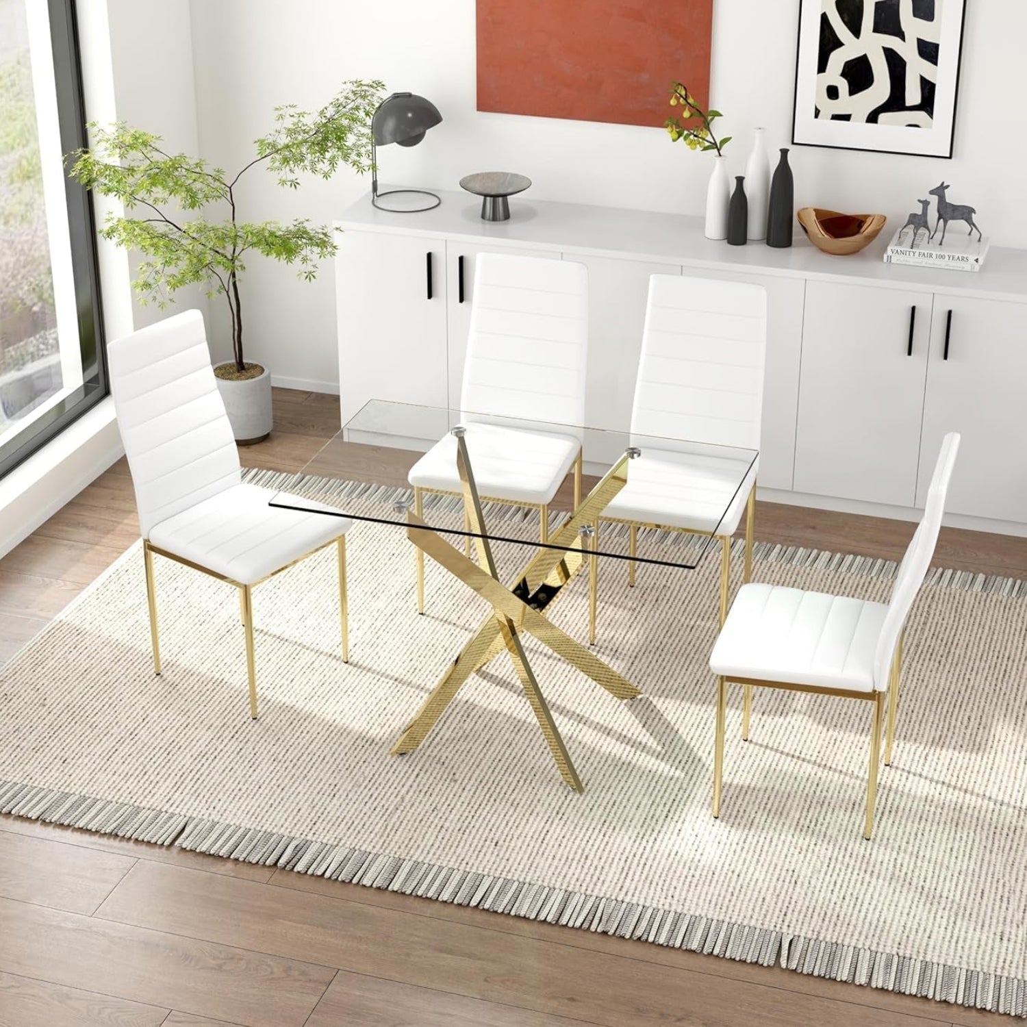 Modern dining set with glass table and white chairs in a bright room.