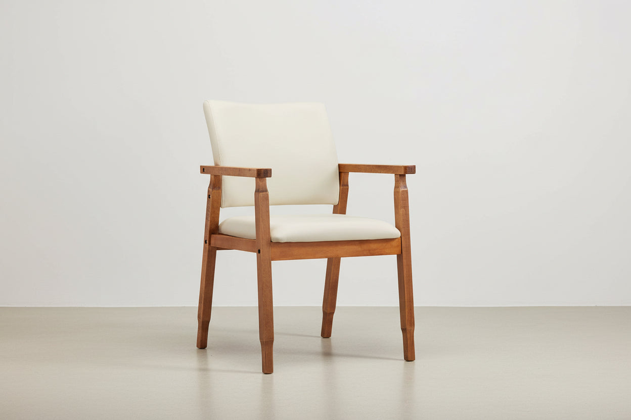 Wooden chair with beige cushion on a white background