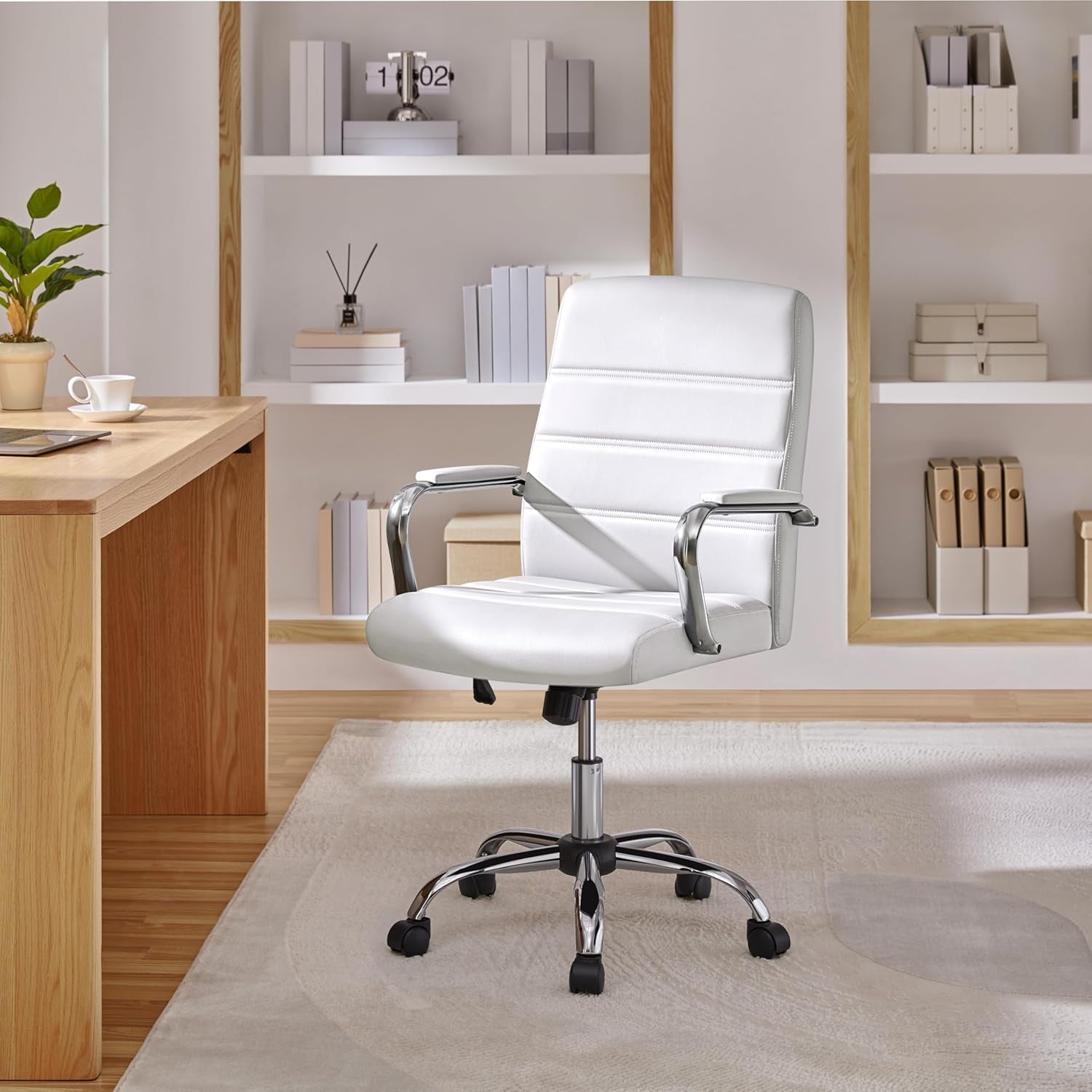 White office chair in a modern office setting with wooden desk and shelves.