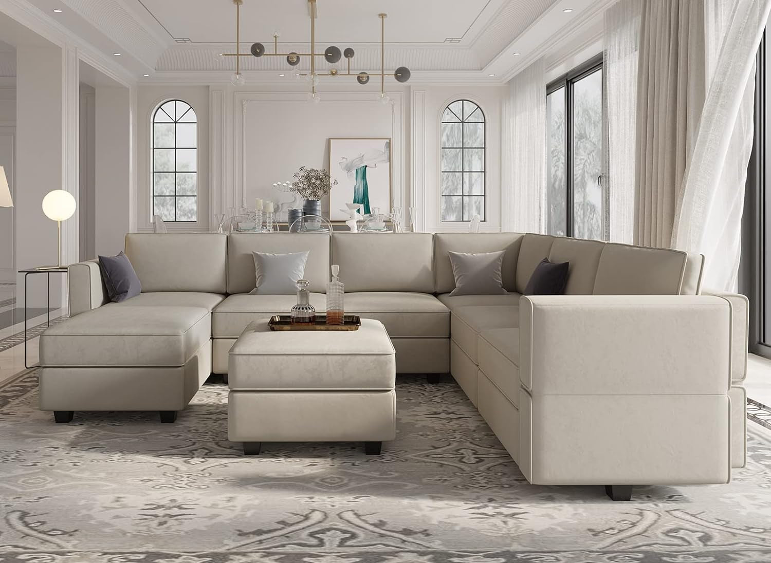 Beige sectional sofa in a stylish living room with large windows and decorative elements.