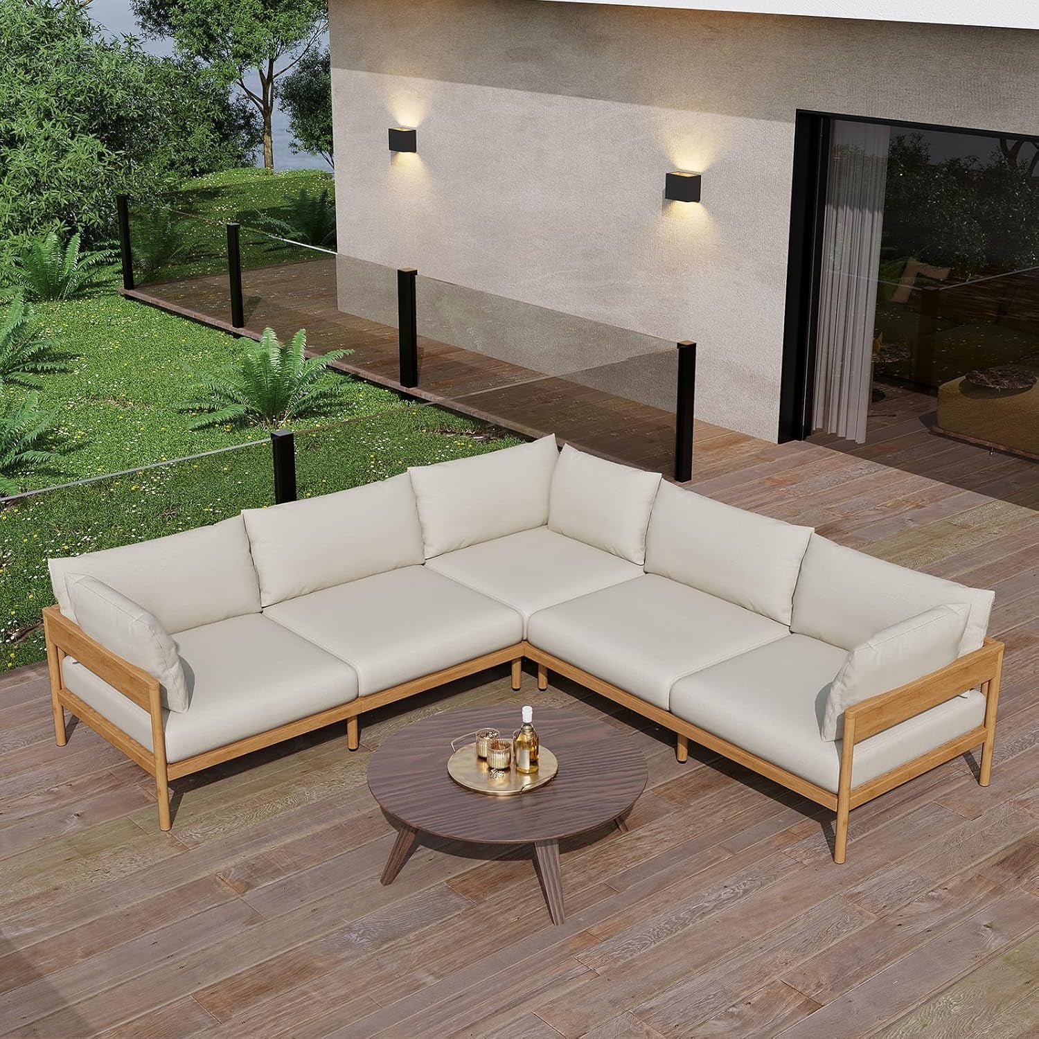 Outdoor sectional sofa with beige cushions on a wooden deck, surrounded by greenery.