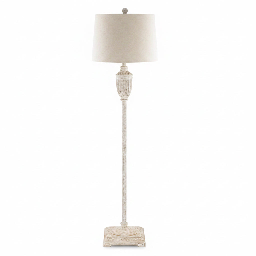Decorative floor lamp with a textured base and white shade on a white background