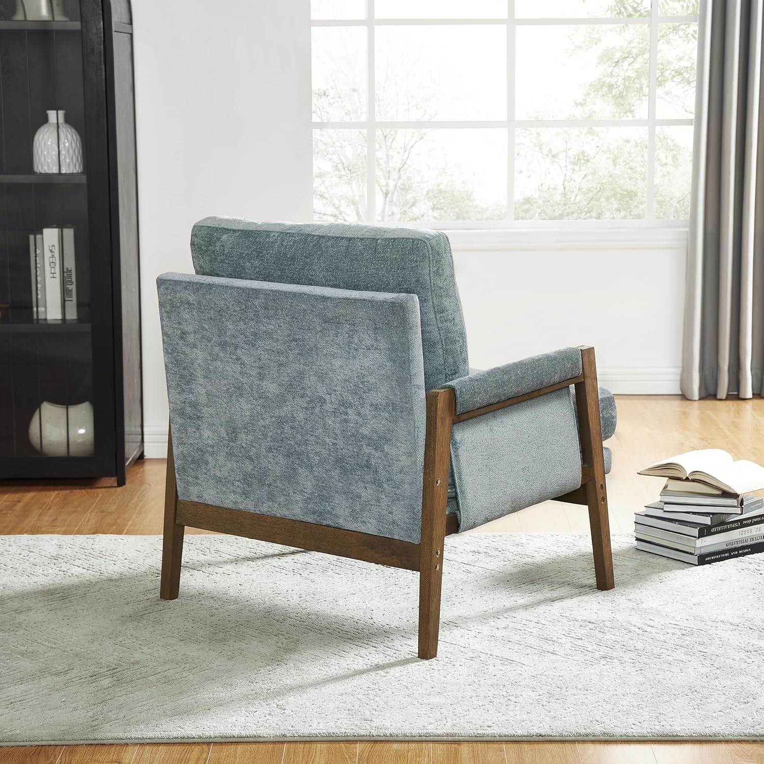 Blue armchair with wooden legs in a living room setting
