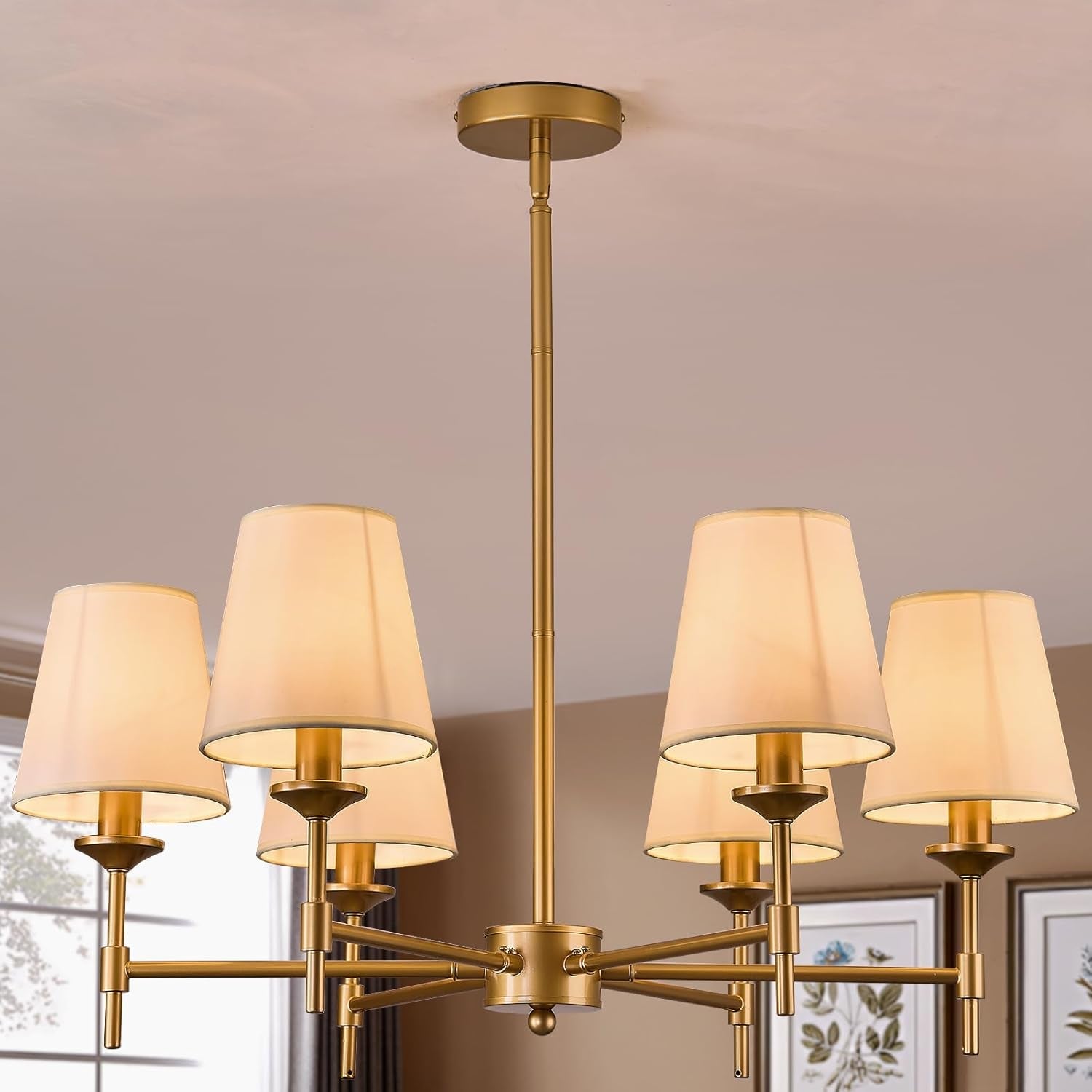 Gold chandelier with beige lampshades in a room setting