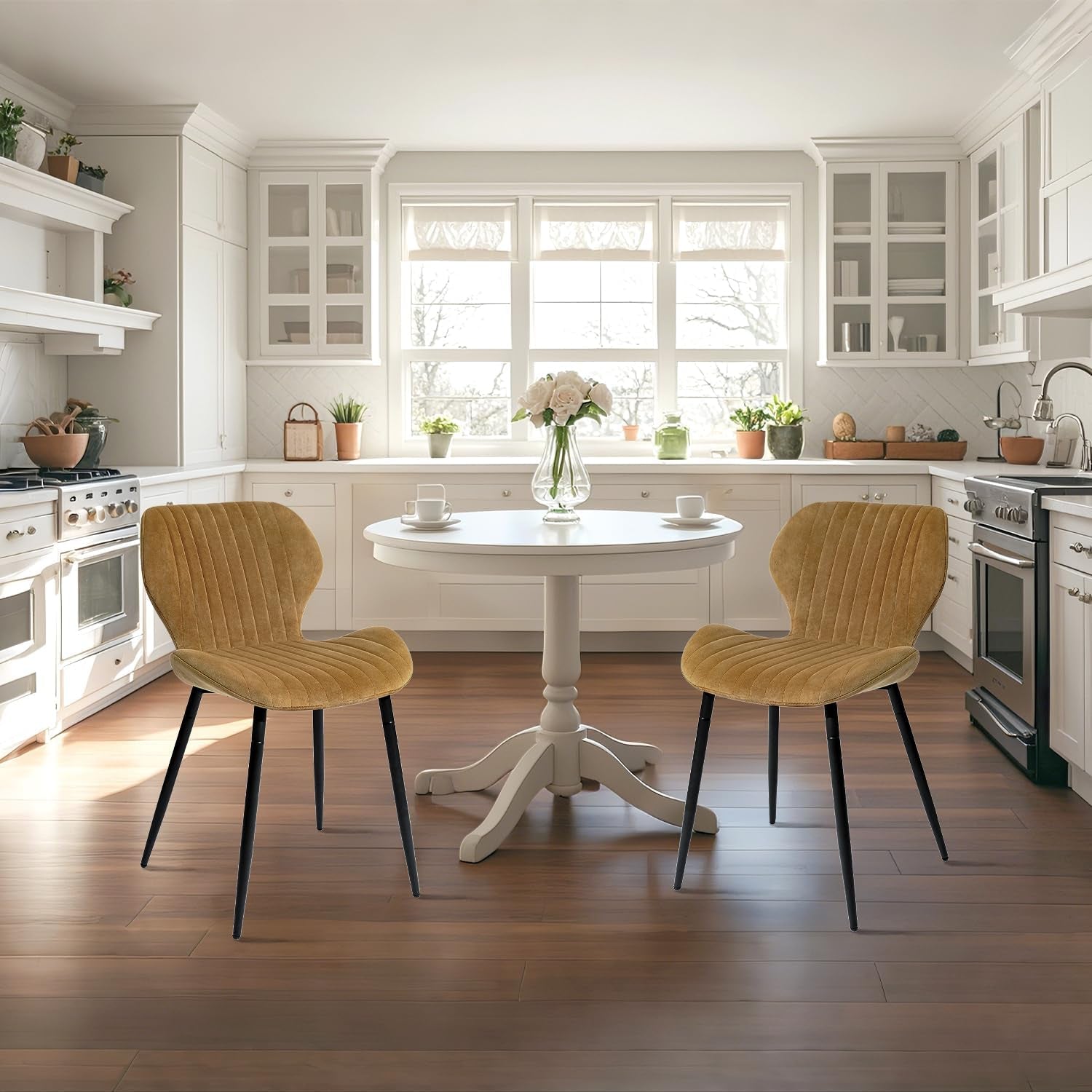 Modern kitchen with a round white table and two yellow chairs.