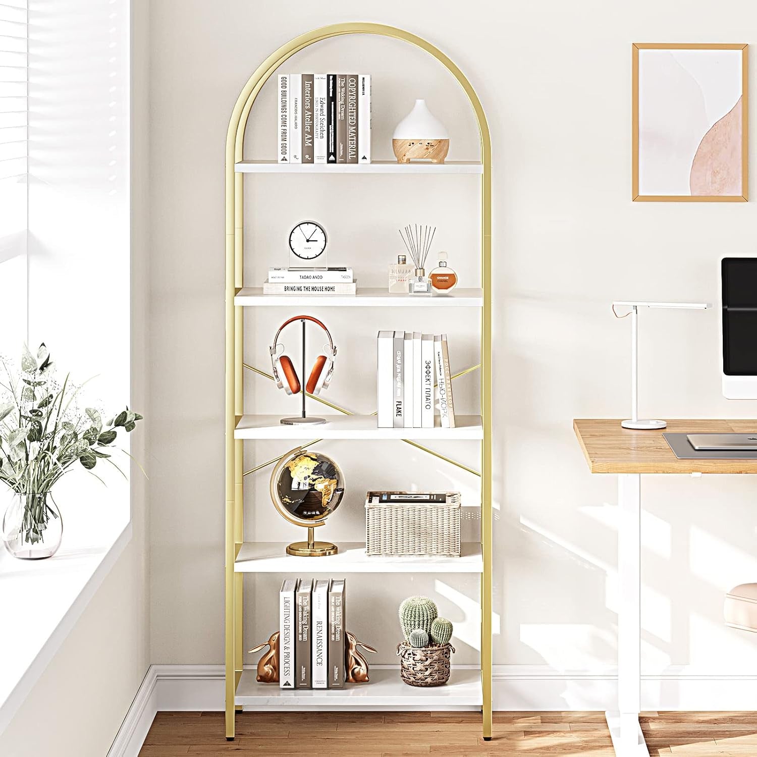 Gold-framed bookshelf with decorative items in a home office setting