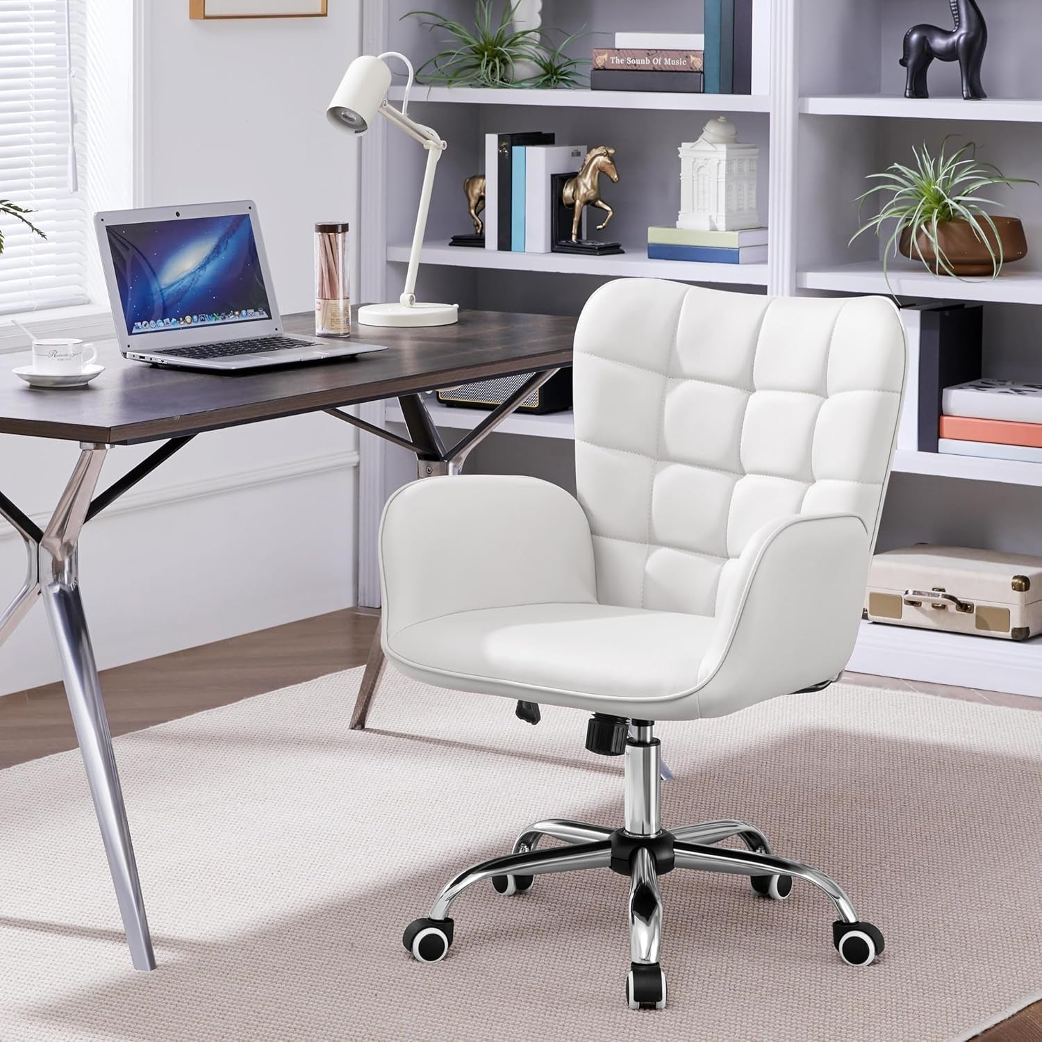 White office chair in a home office setting with a desk and shelves.