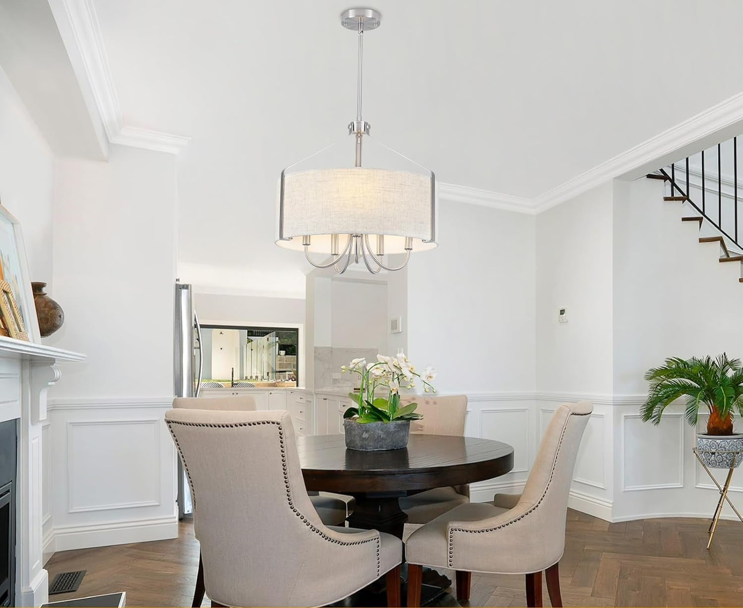 Dining room with a round table and chairs, featuring different ceiling types.
