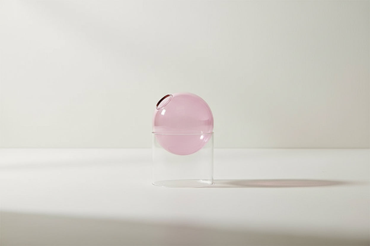 Pink spherical object with dimensions labeled on a white background