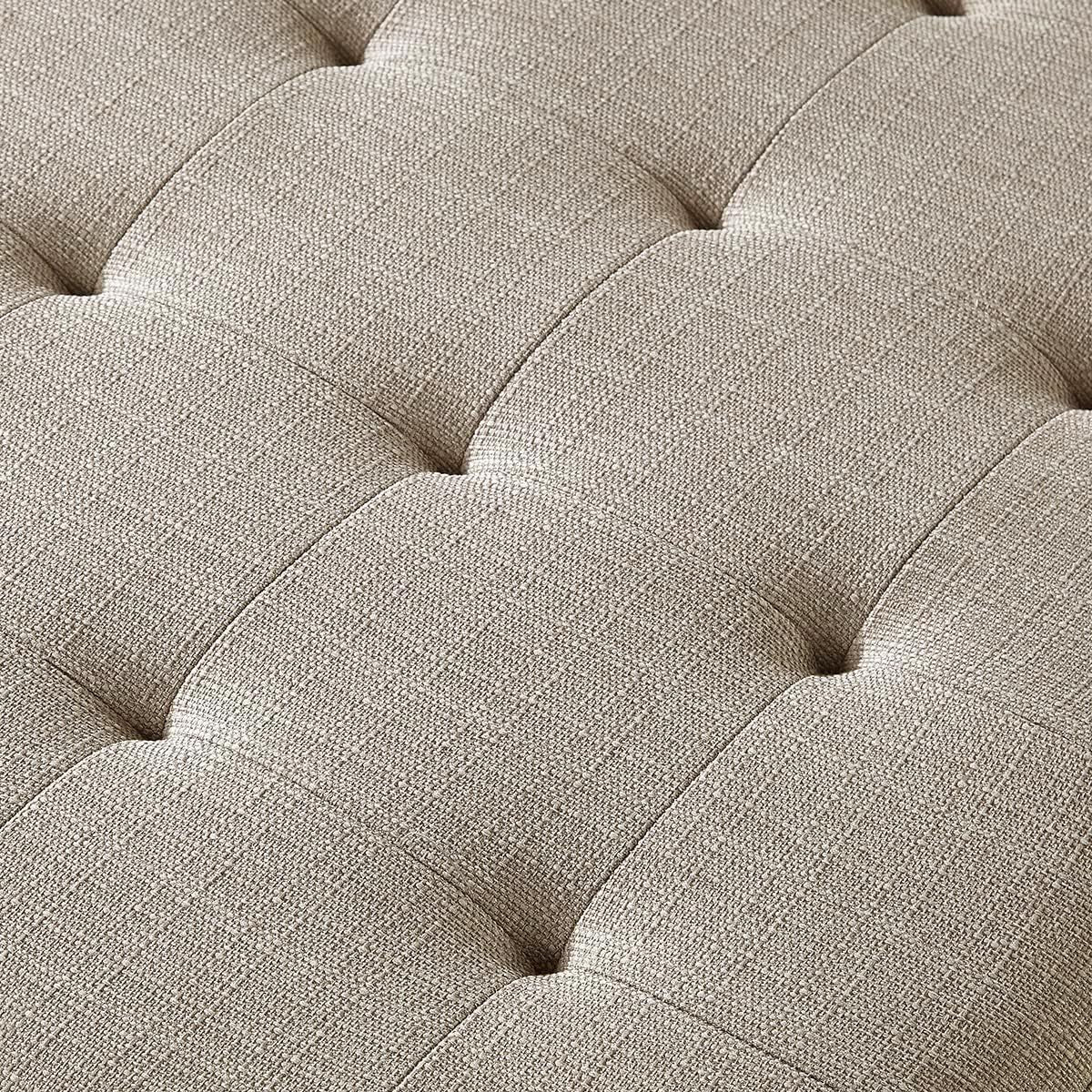 Close-up of a tufted beige fabric surface