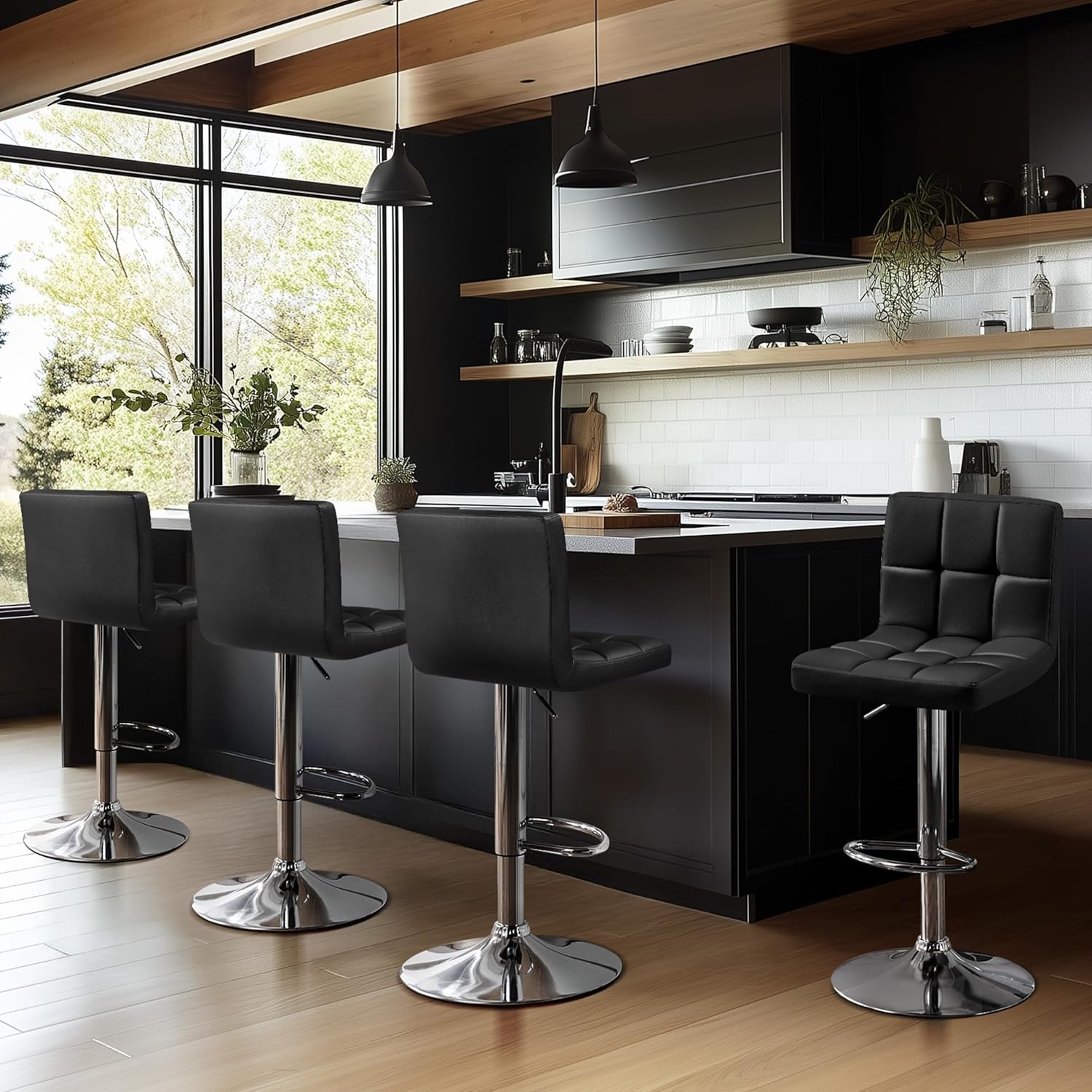 Modern kitchen with black bar stools and a large window view.