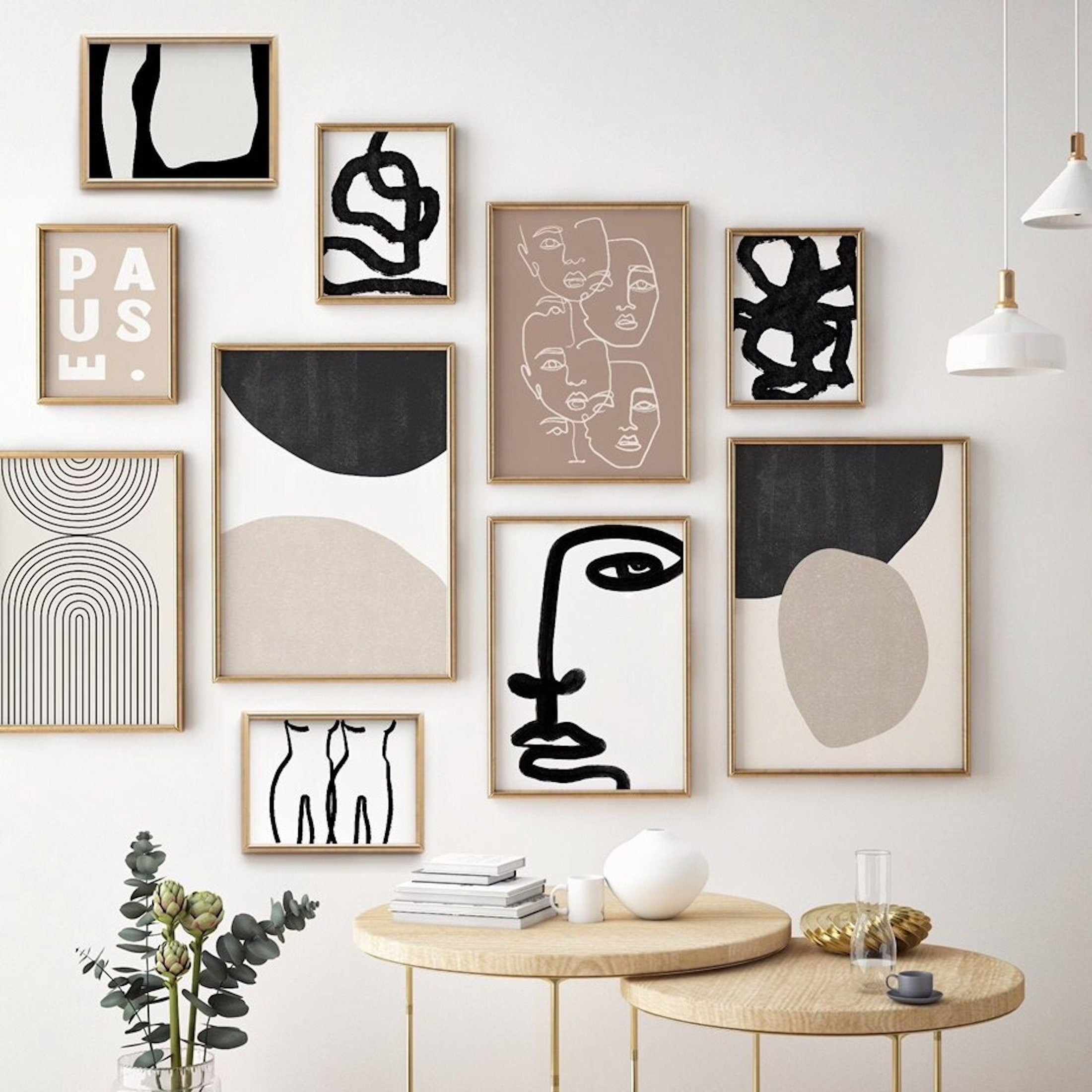 Wall with various abstract art prints in neutral tones
