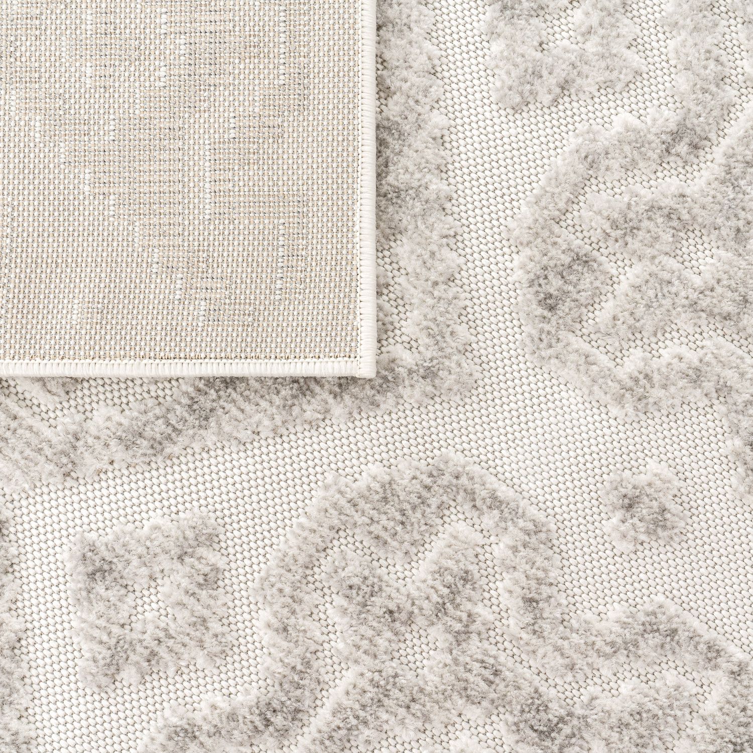 Close-up of a textured gray rug with a grid pattern