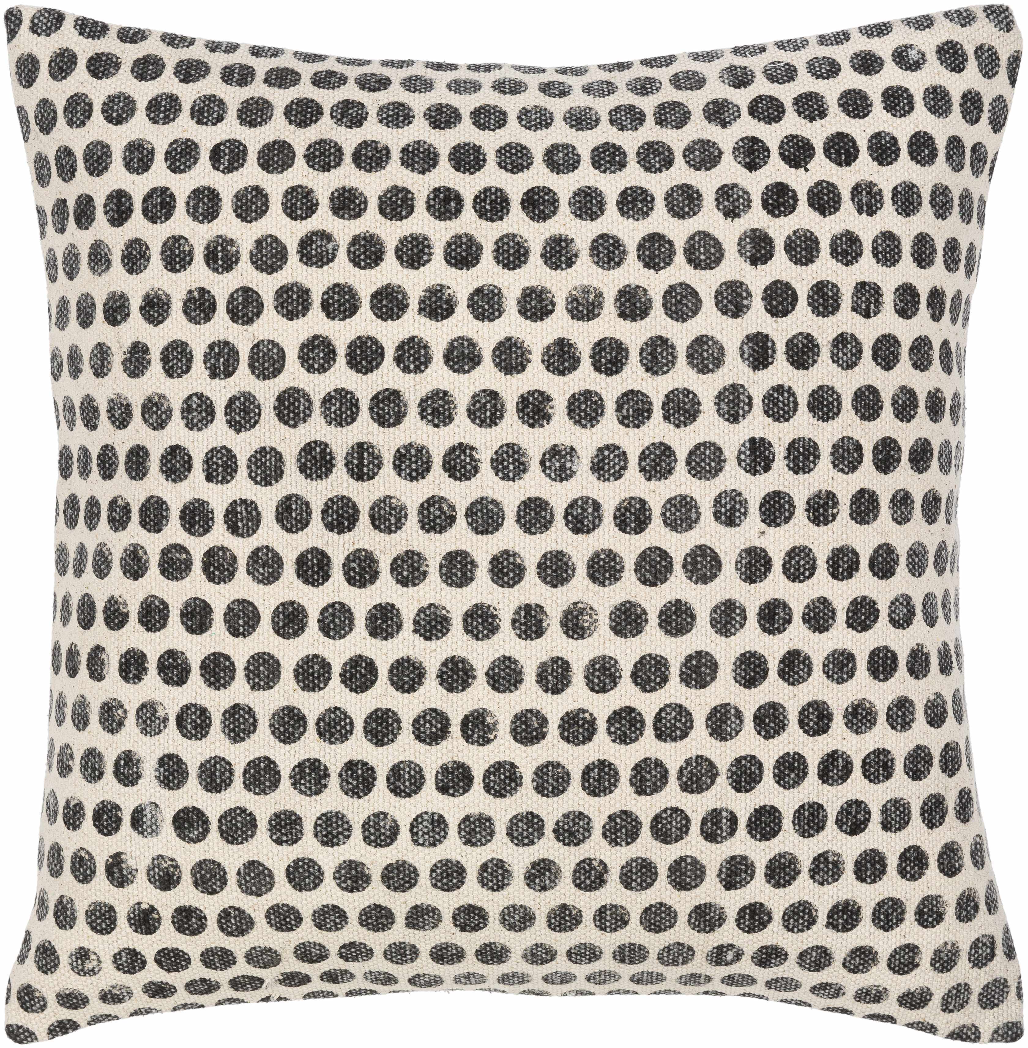 Decorative pillow with black dot pattern on a beige background