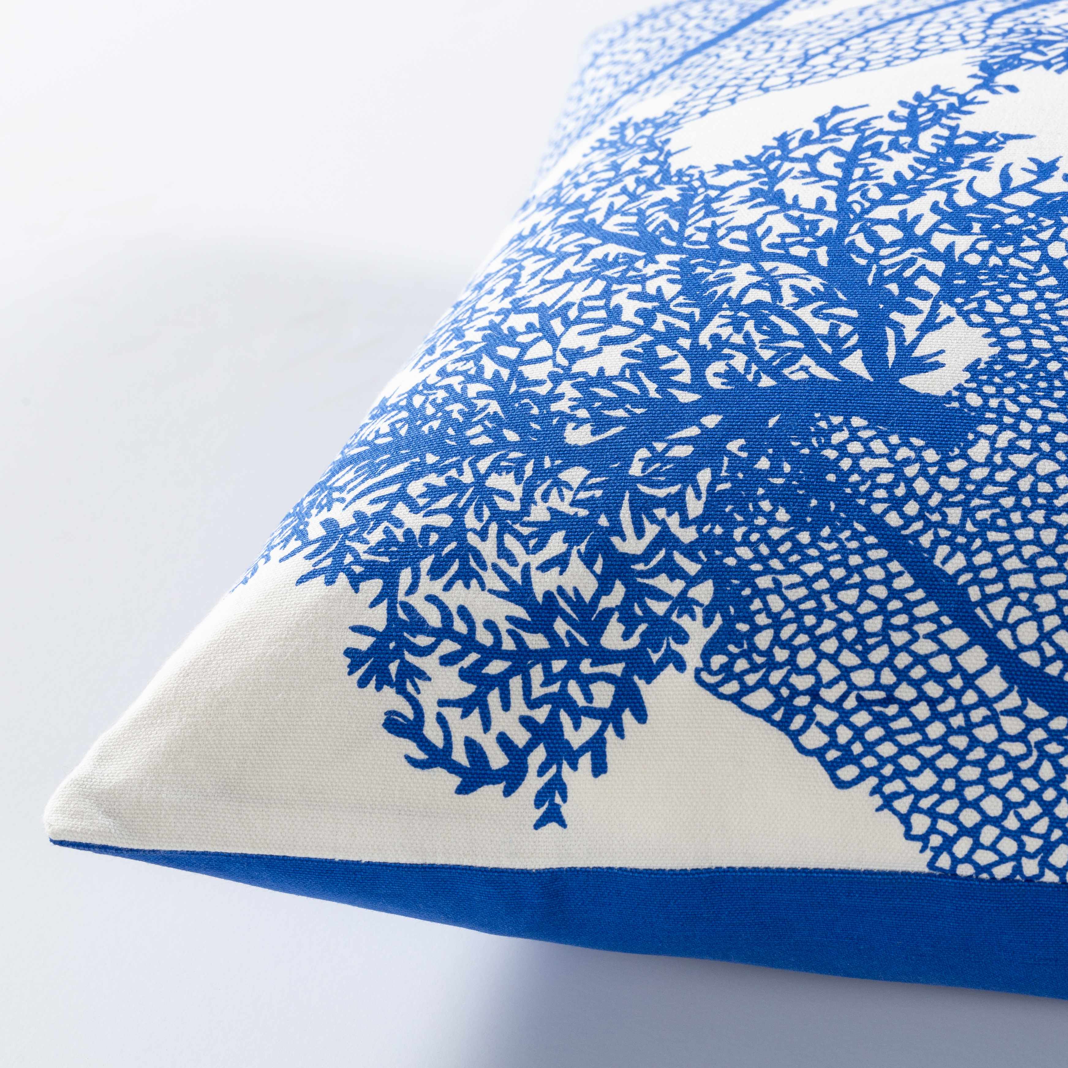 Cushion with blue coral pattern on a white background