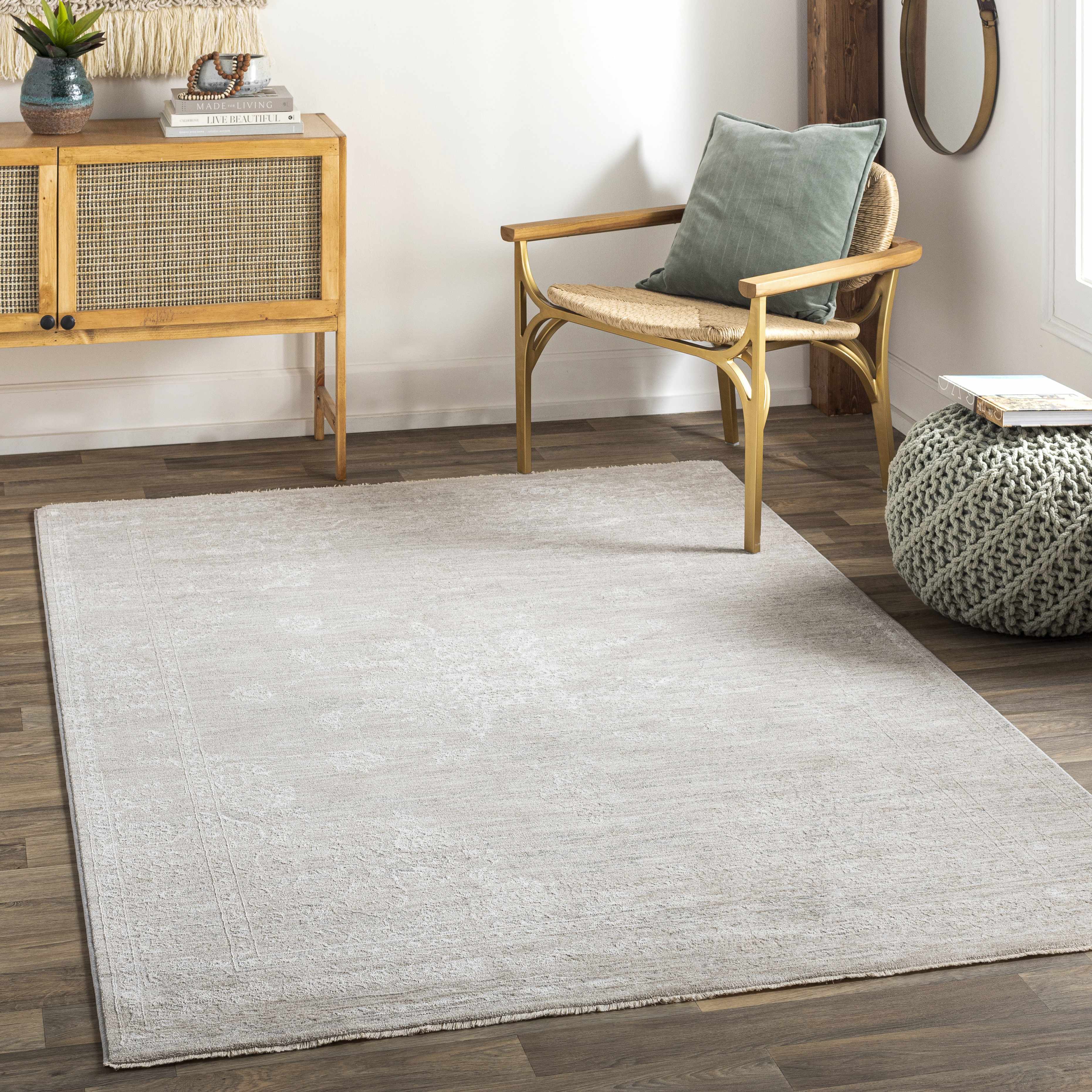 Textured beige rug with a subtle pattern on a plain background