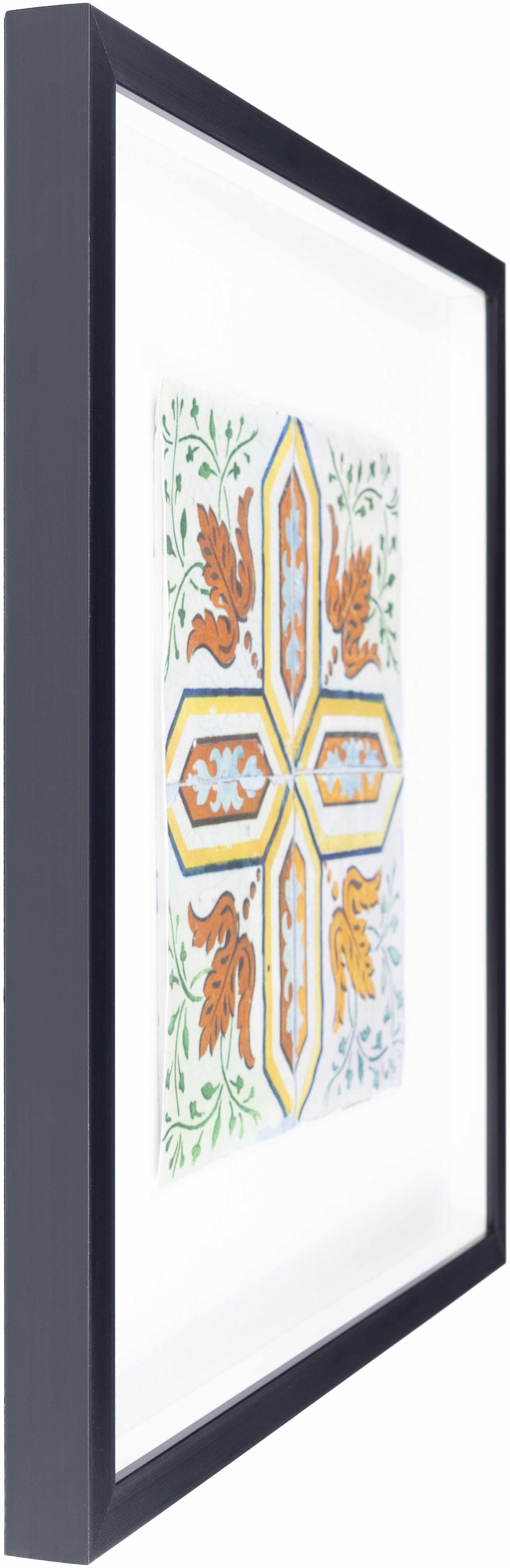 Decorative cross with floral elements in a black frame