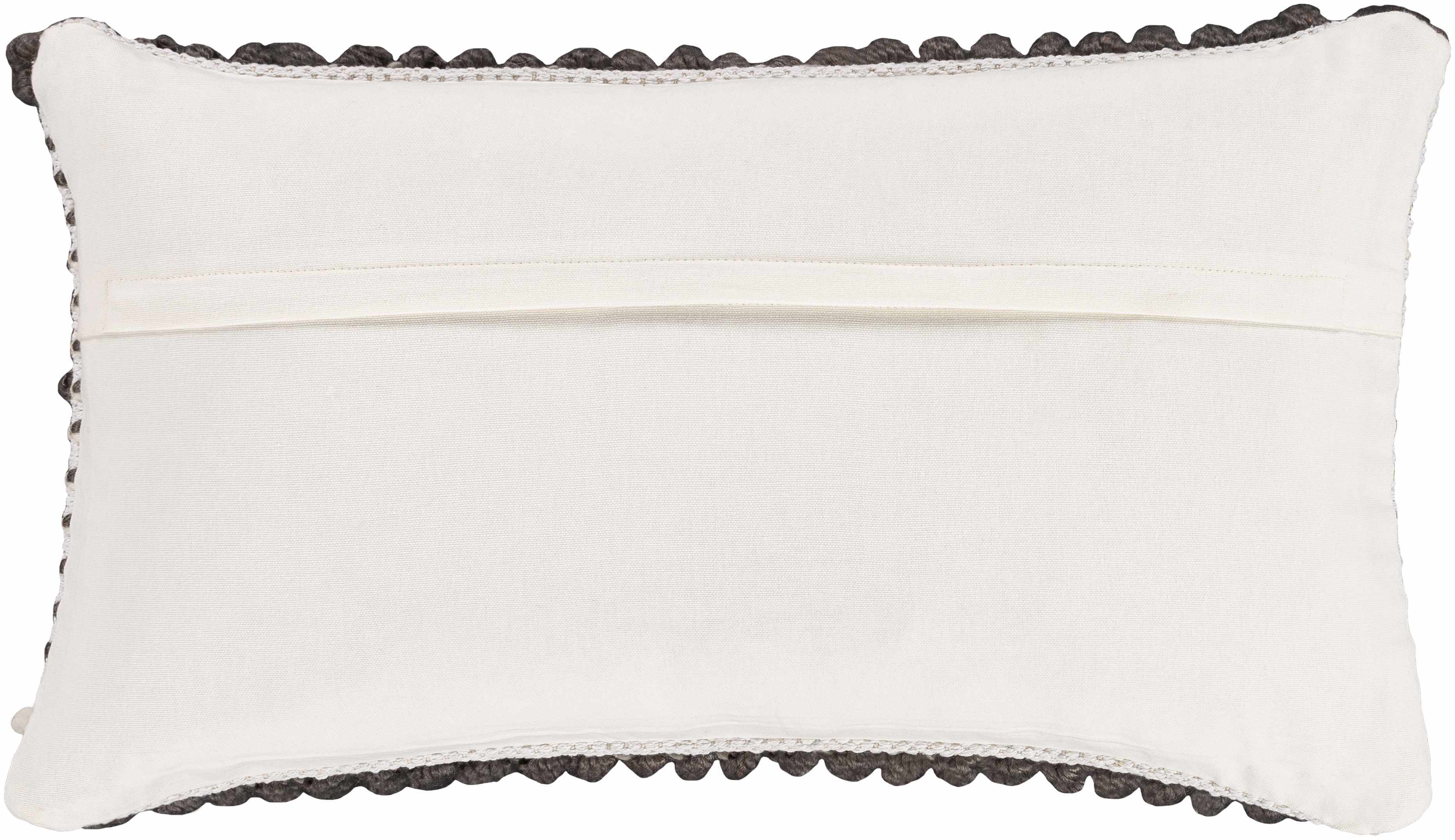 White pillow with black pom-pom trim on a white background
