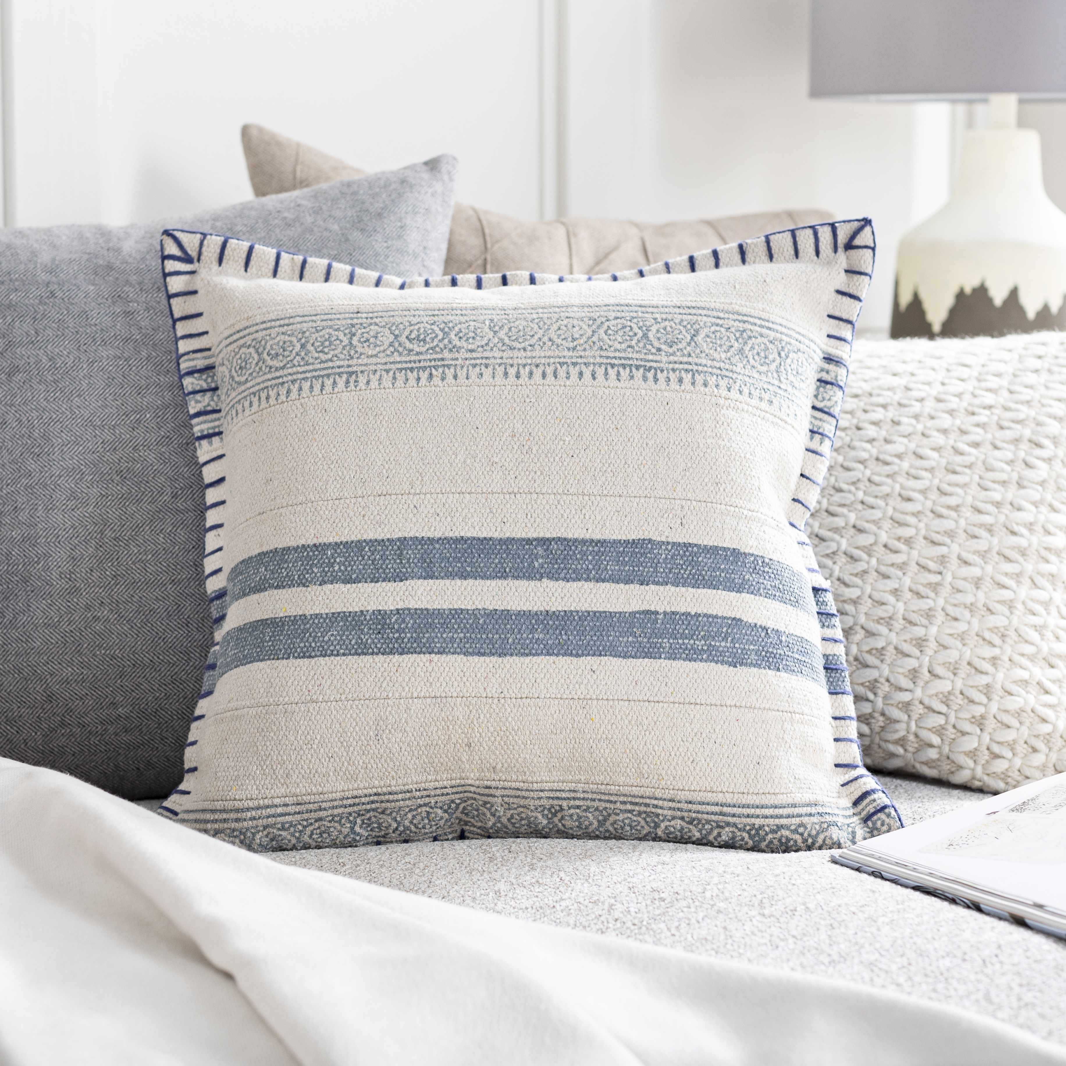 Decorative pillow with blue stripes on a sofa