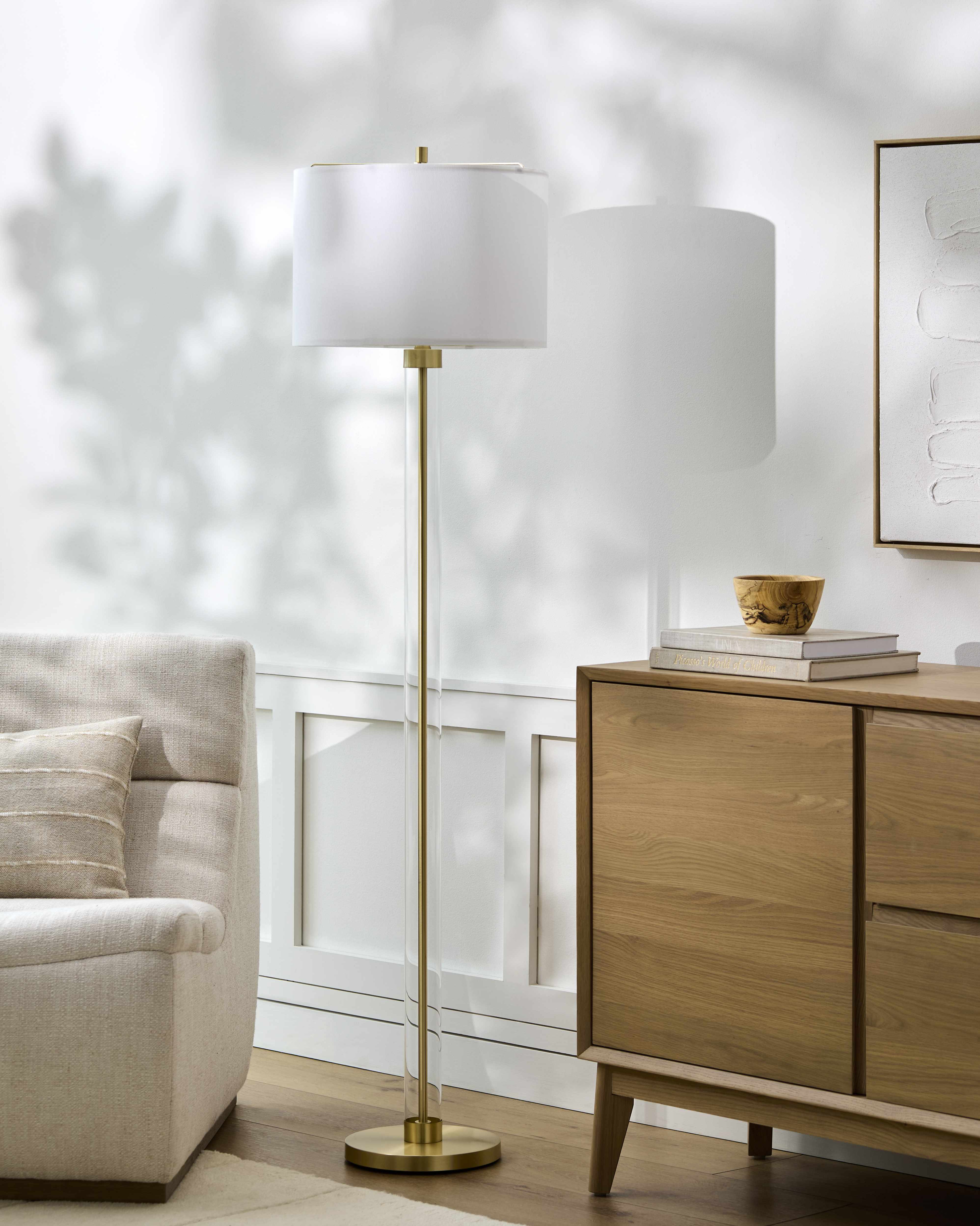 Living room with a floor lamp, wooden sideboard, and sofa.