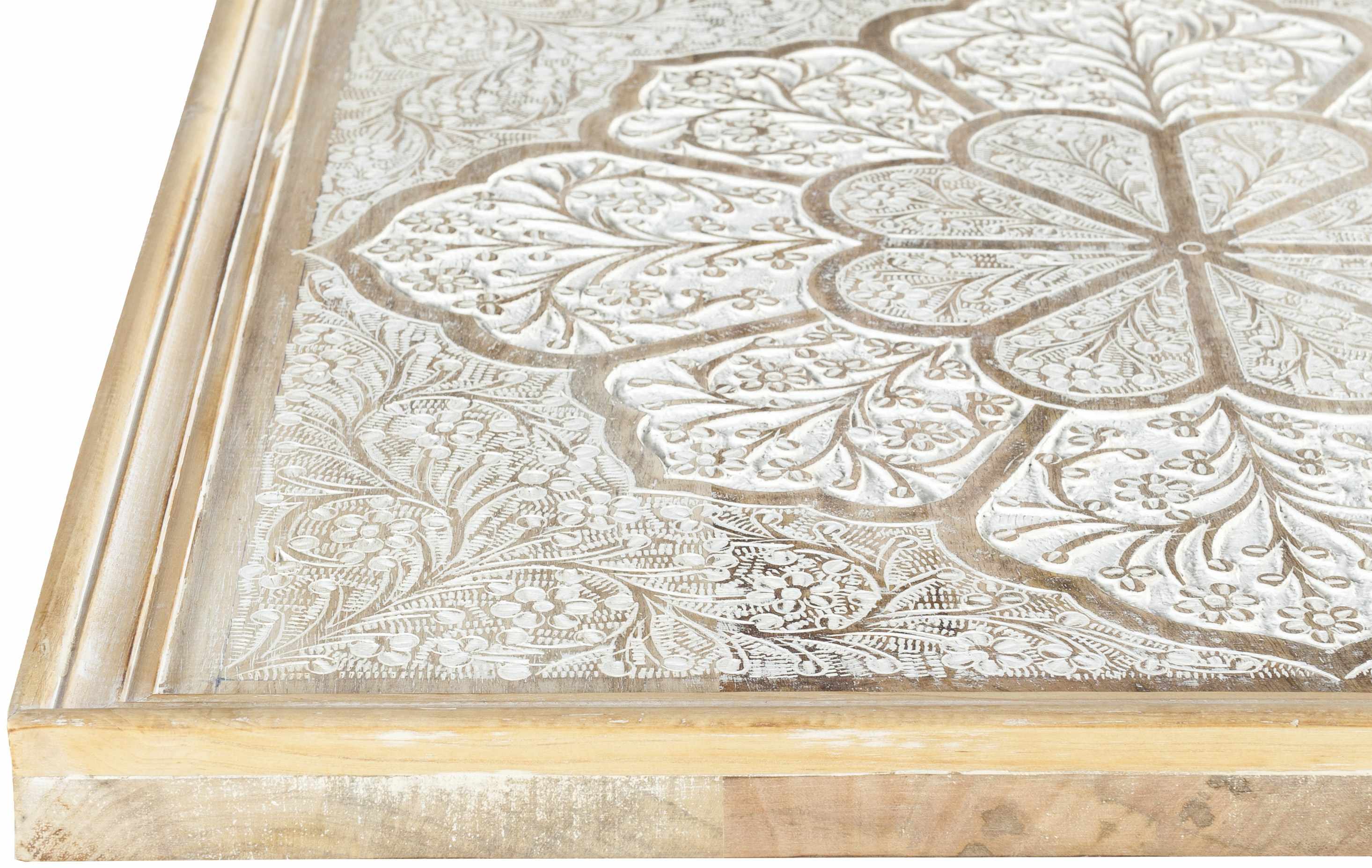 Decorative wooden block with intricate floral patterns on a white background