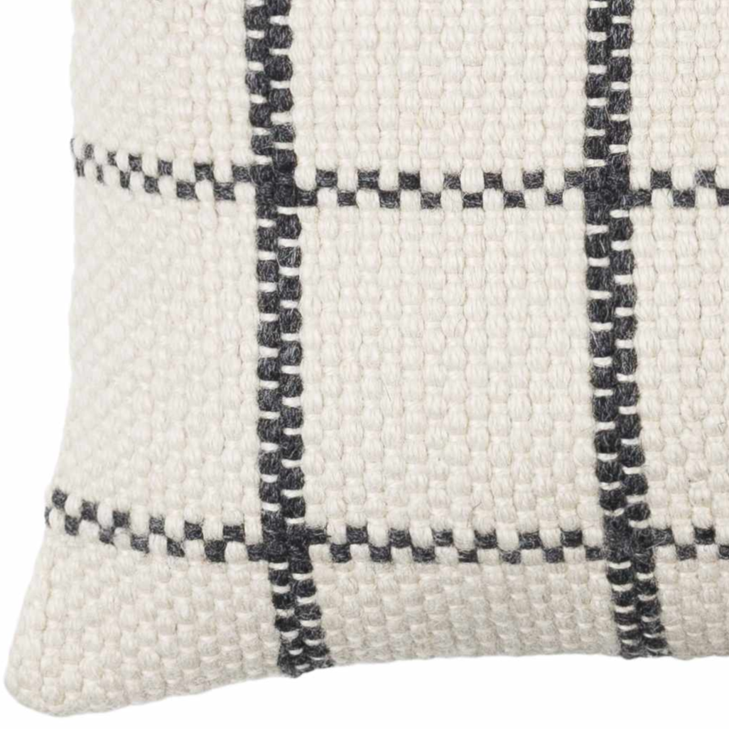 Textured pillow with a black and white checkered pattern on a white background