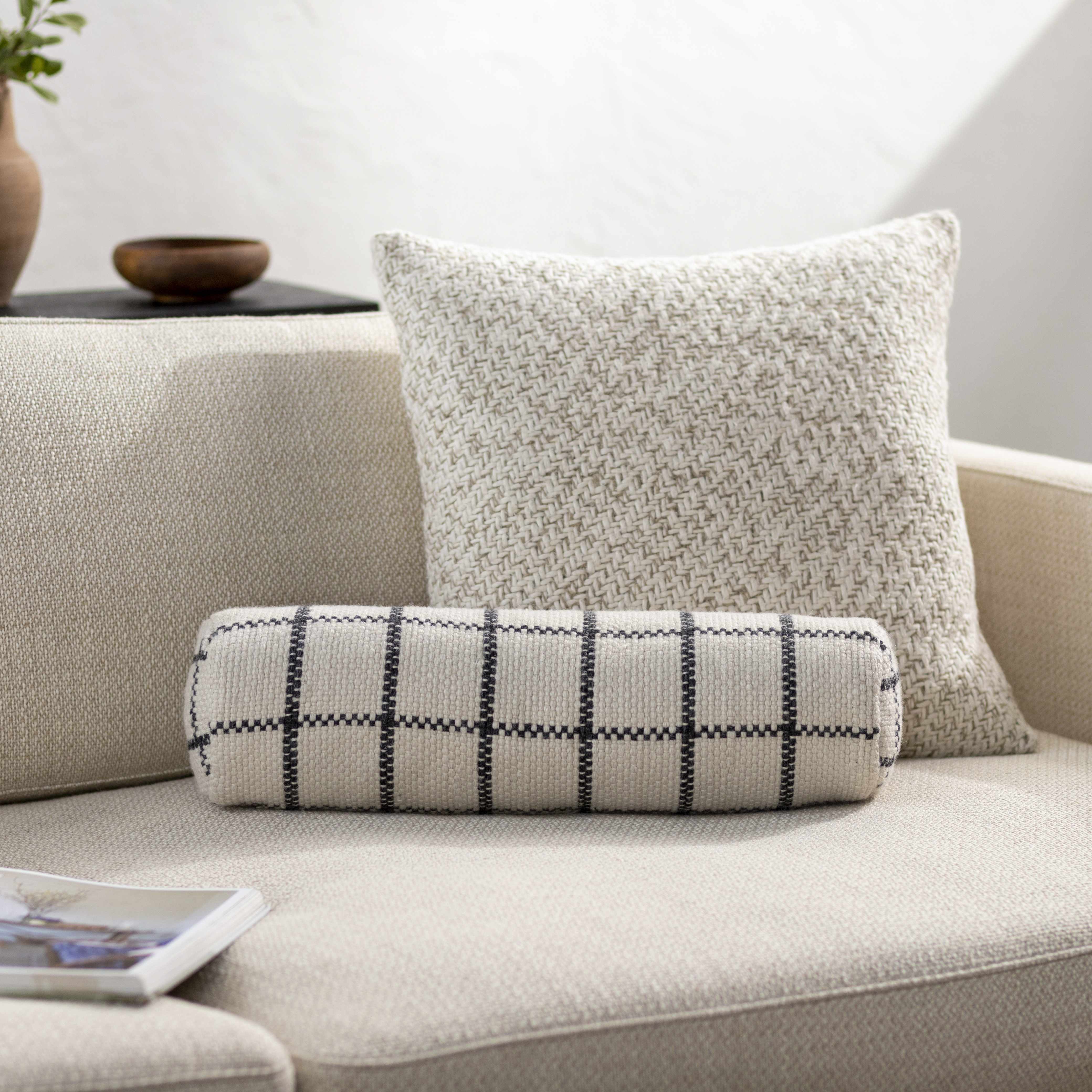 Decorative pillows on a sofa with a neutral background