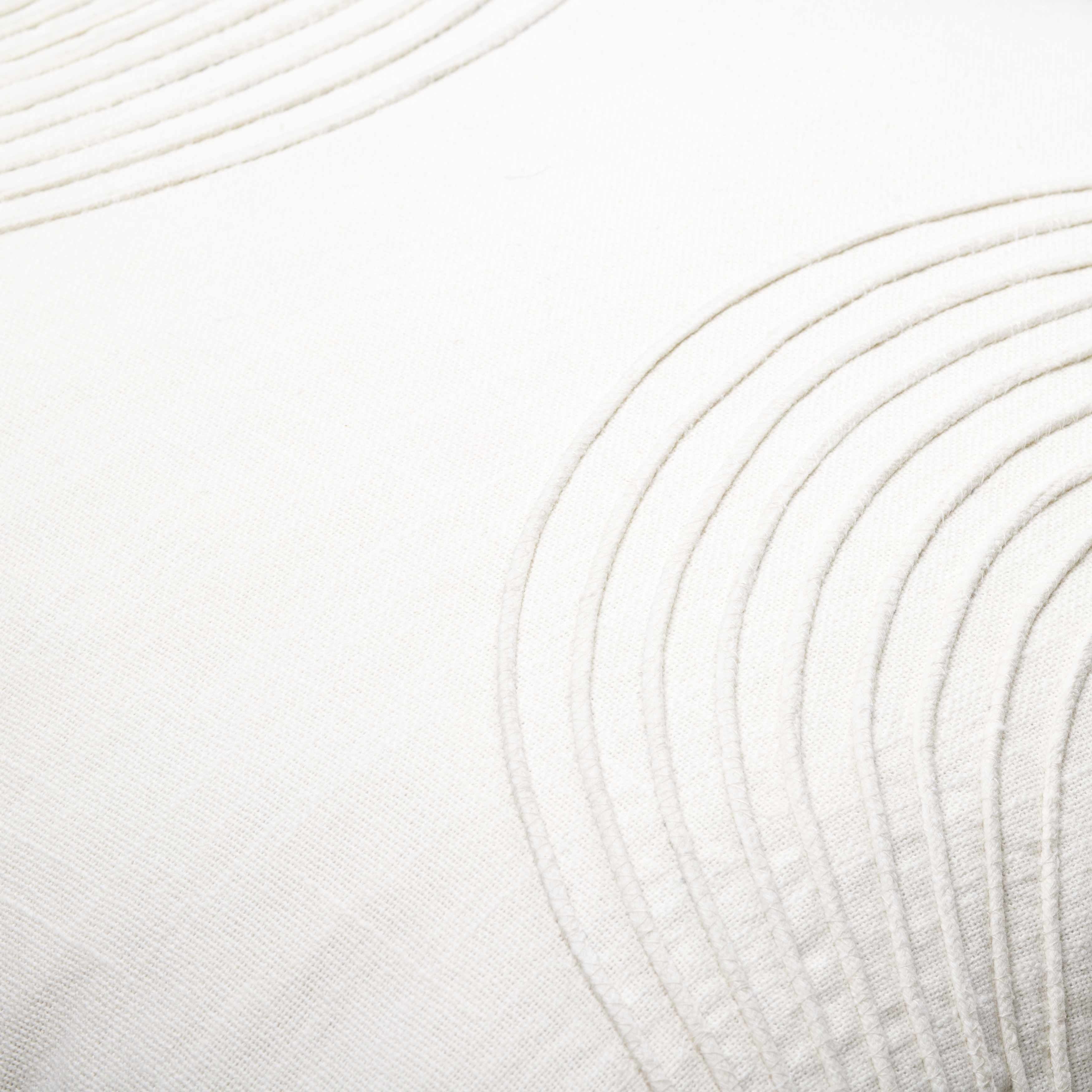 Close-up of white yarn with circular patterns on a white background