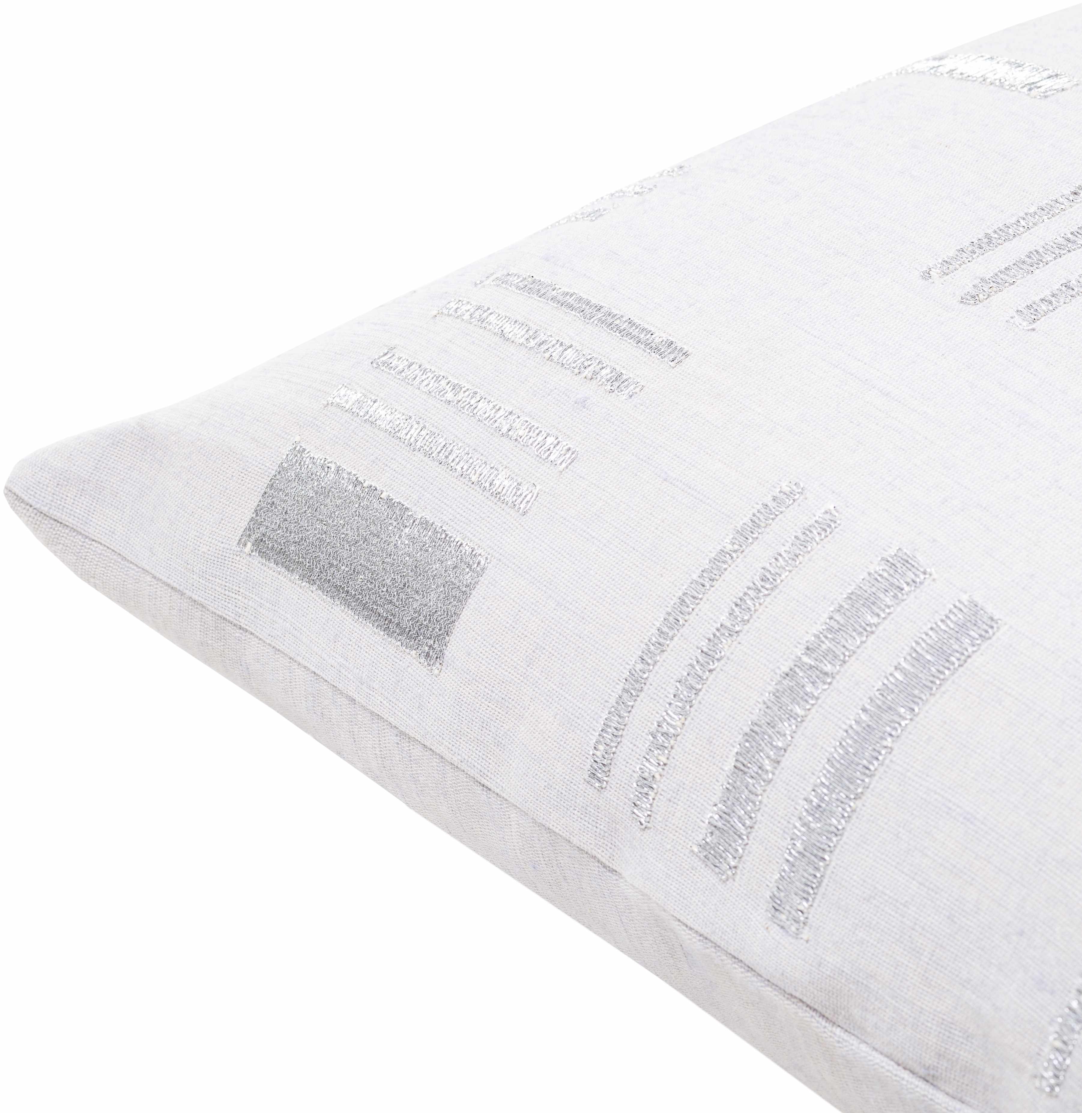 White pillow with silver embroidery on a white background